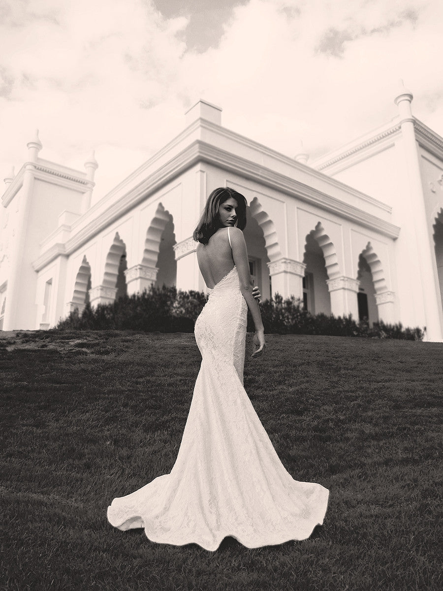 Dramatic open back lace bridal gown with horsehair scalloped hemline and eyelash lace detailing. Isla by Lauren Elaine Bridal.