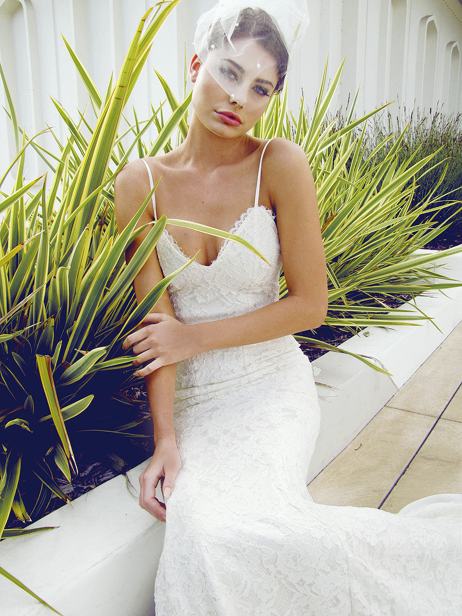 Designer lace wedding gown with plunging sweetheart bodice.