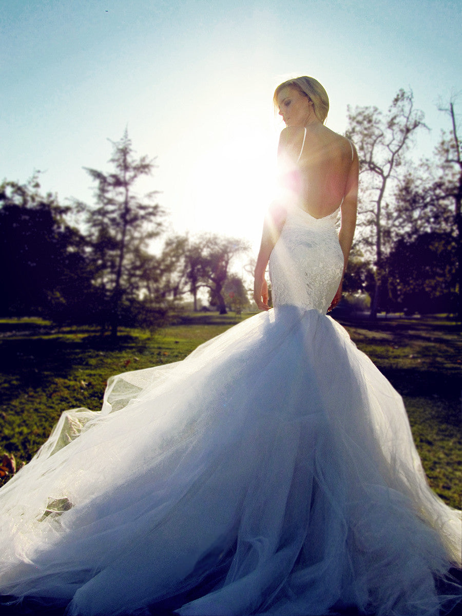 Backless mermaid wedding gown with detachable cathedral train.