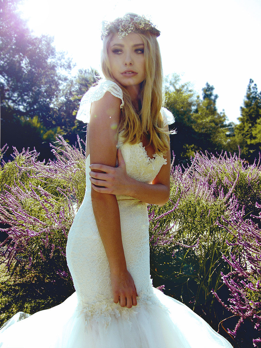 Vintage inspired lace and tulle mermaid wedding dress with open back and ruffle sleeves.