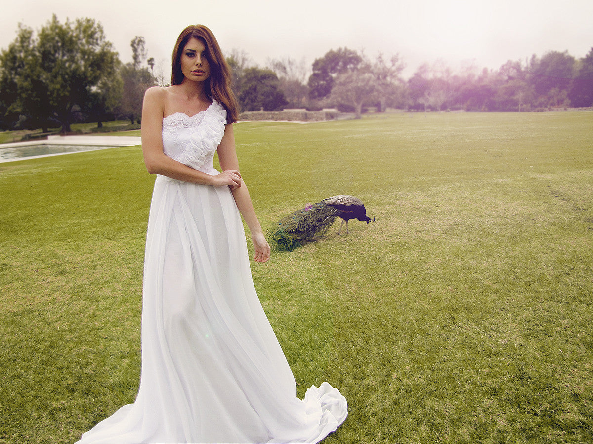 Lace and pearl wedding gown by Lauren Elaine Bridal. One-shoulder dress with ruffles. As seen on the red carpet.