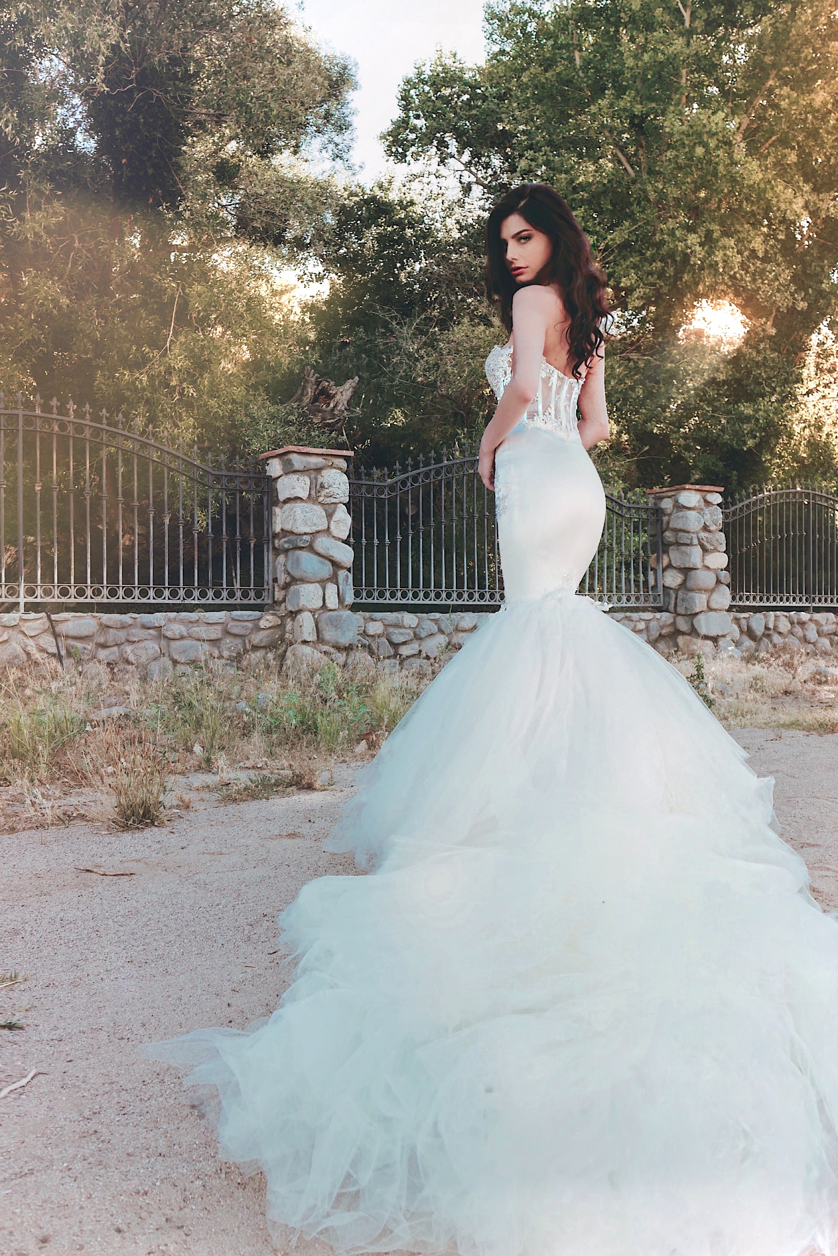 Wide shot of satin and lace mermaid wedding dress with detachable train