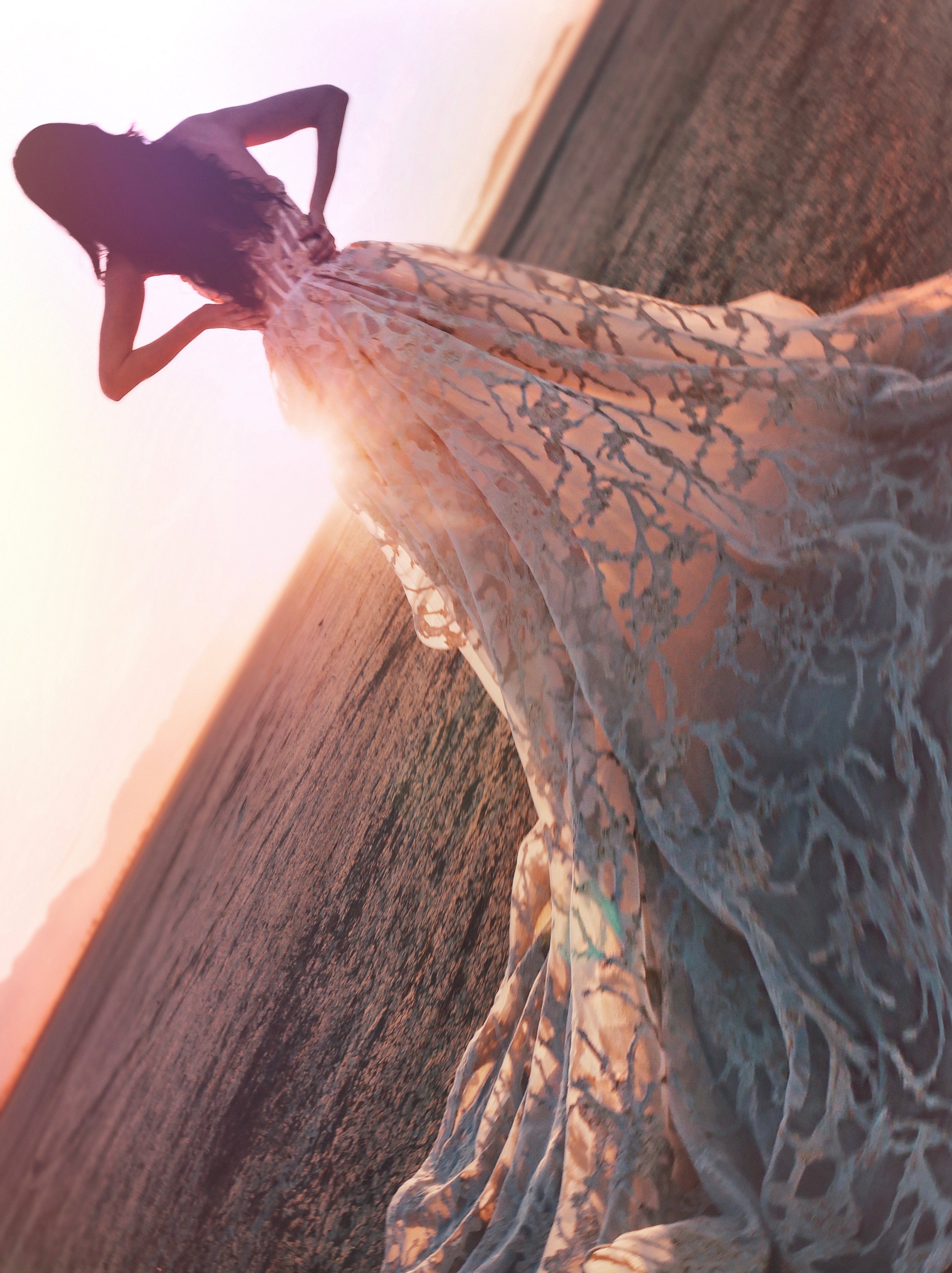 Tilted sunset image of white and gold ballgown train