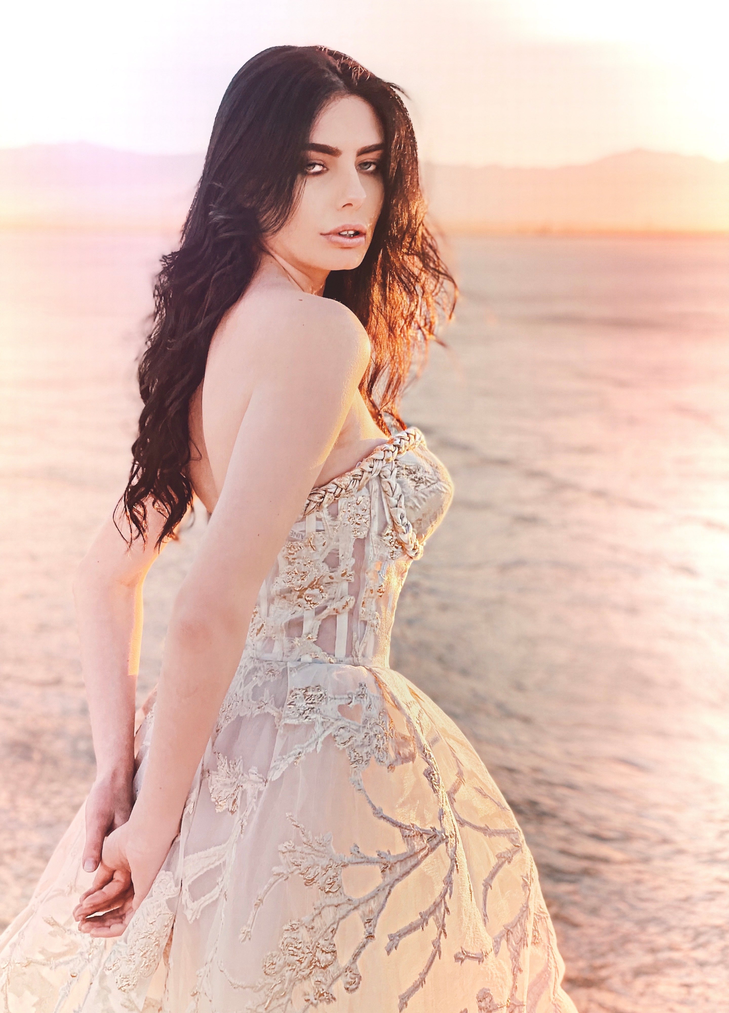 Closeup of gold bustier dress looking over shoulder