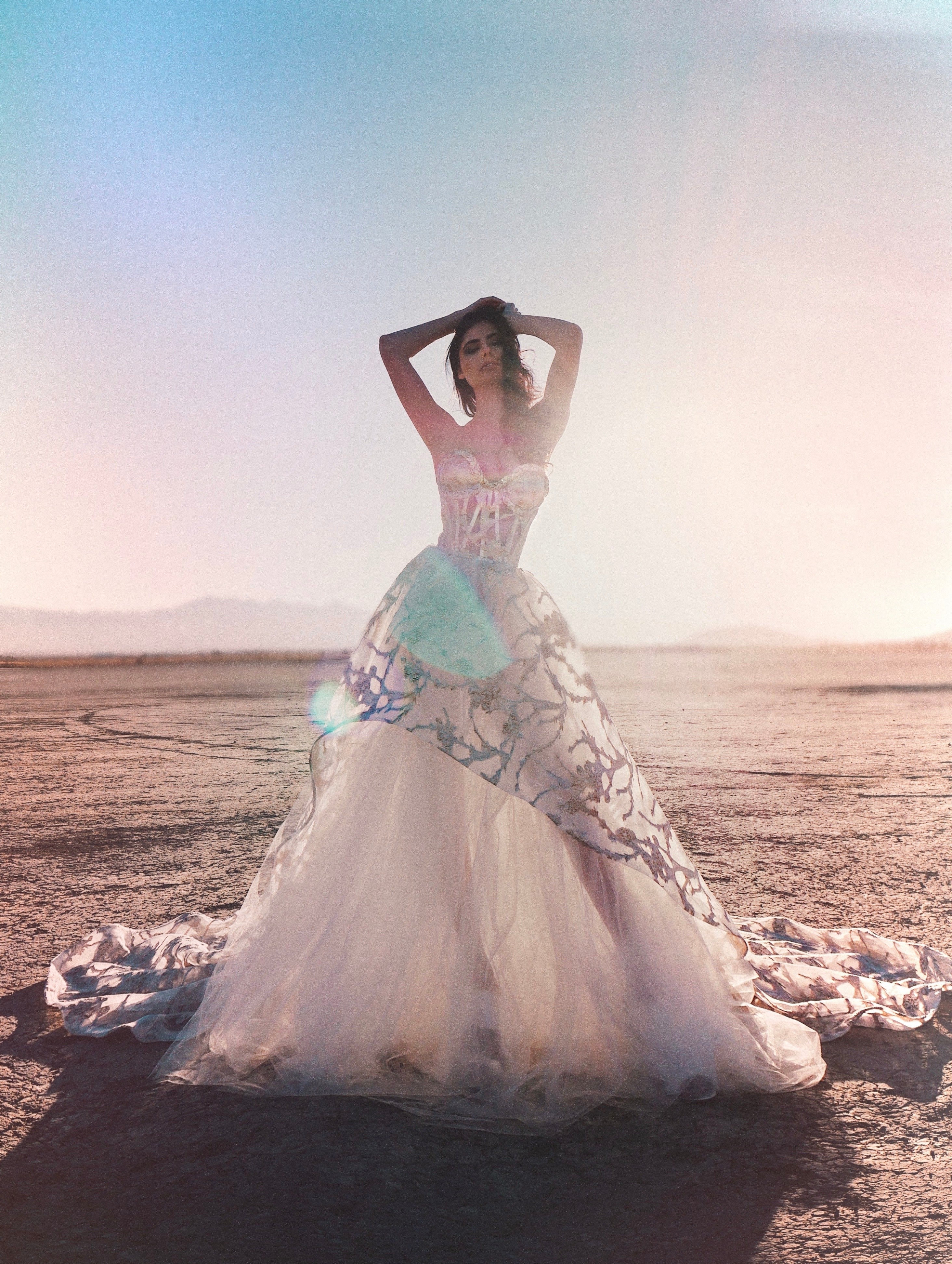 Gold asymmetrical wedding dress with hands on head