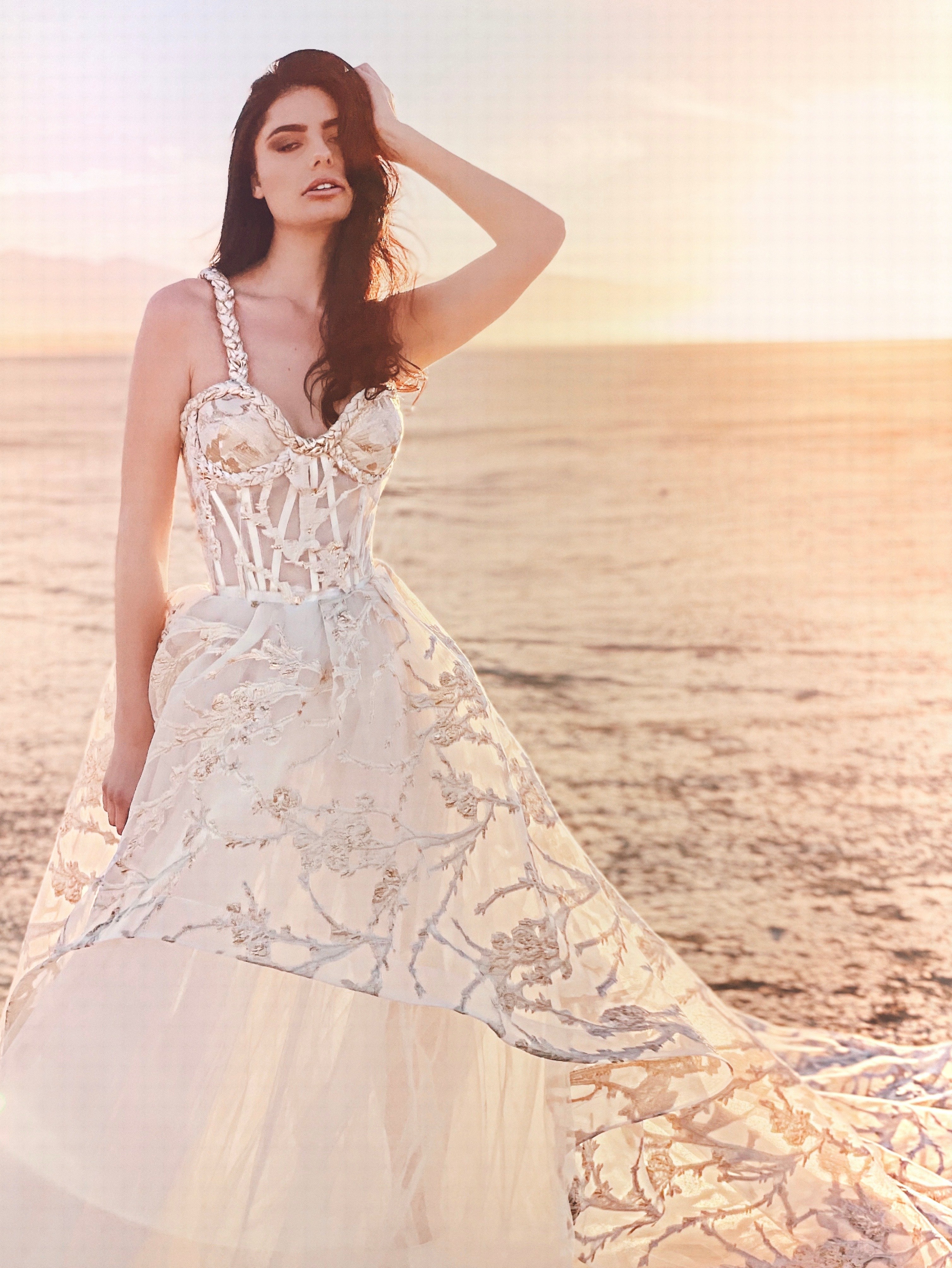 White and gold asymmetrical tiered skirt with hand on head