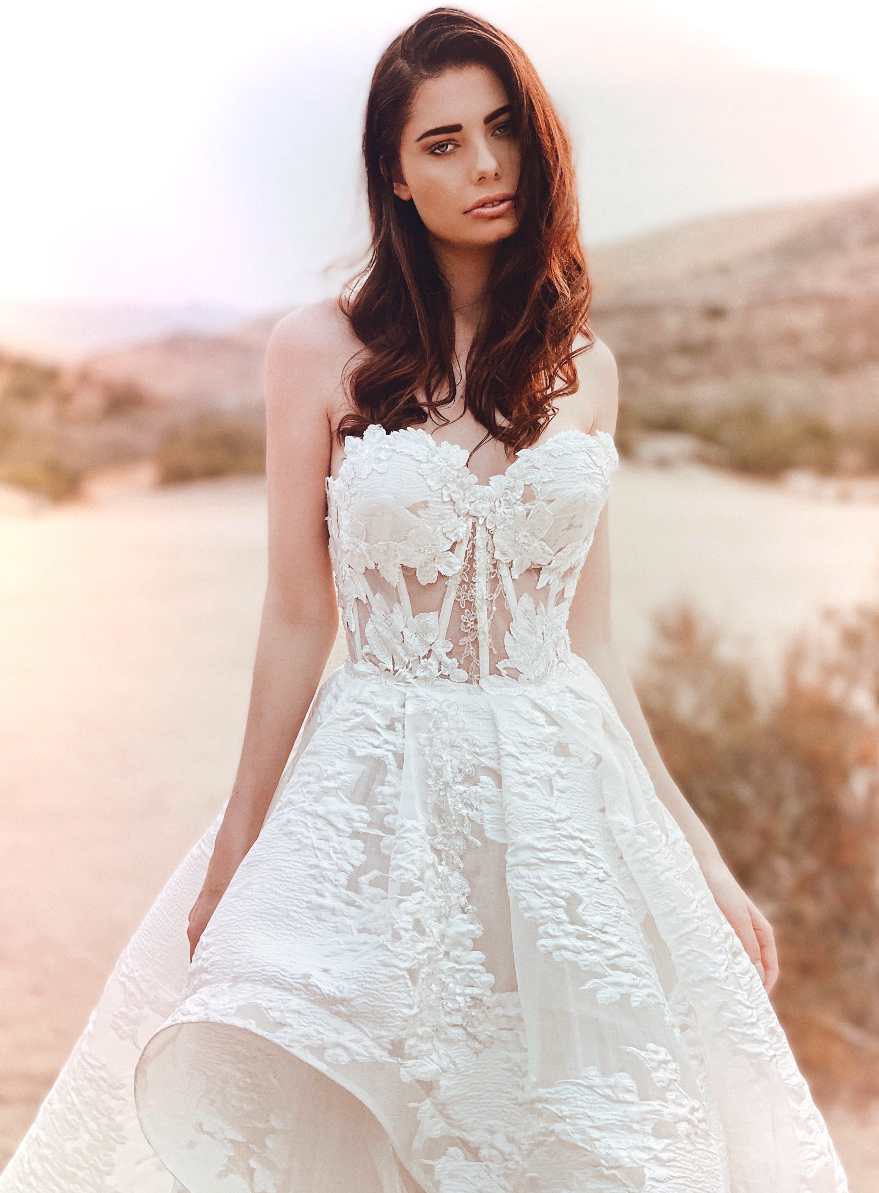 Front view of a lace corset wedding dress with organza overlay by Lauren Elaine.