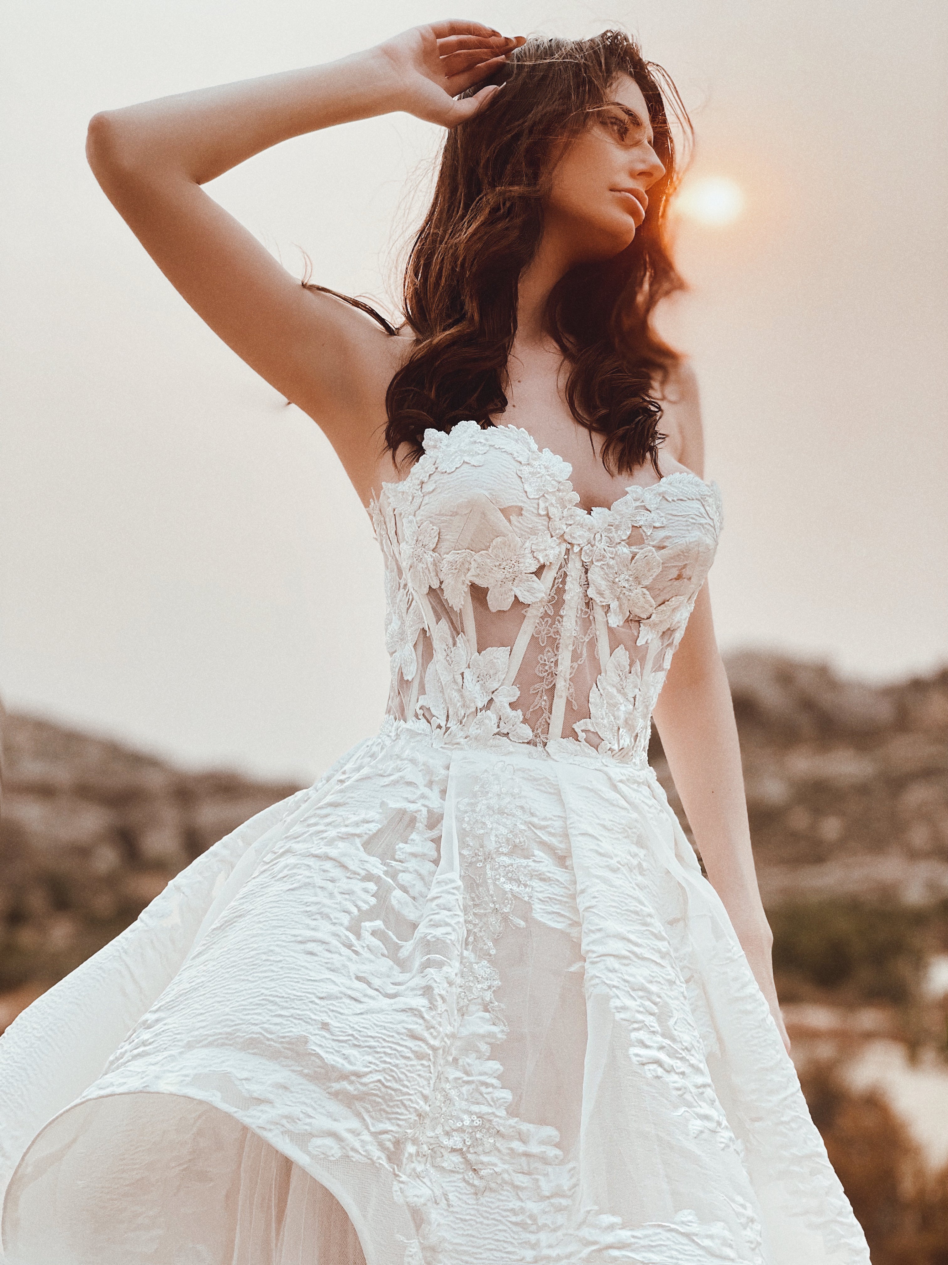 Detail image of a lace corset wedding dress with organza ball gown skirt by Lauren Elaine.
