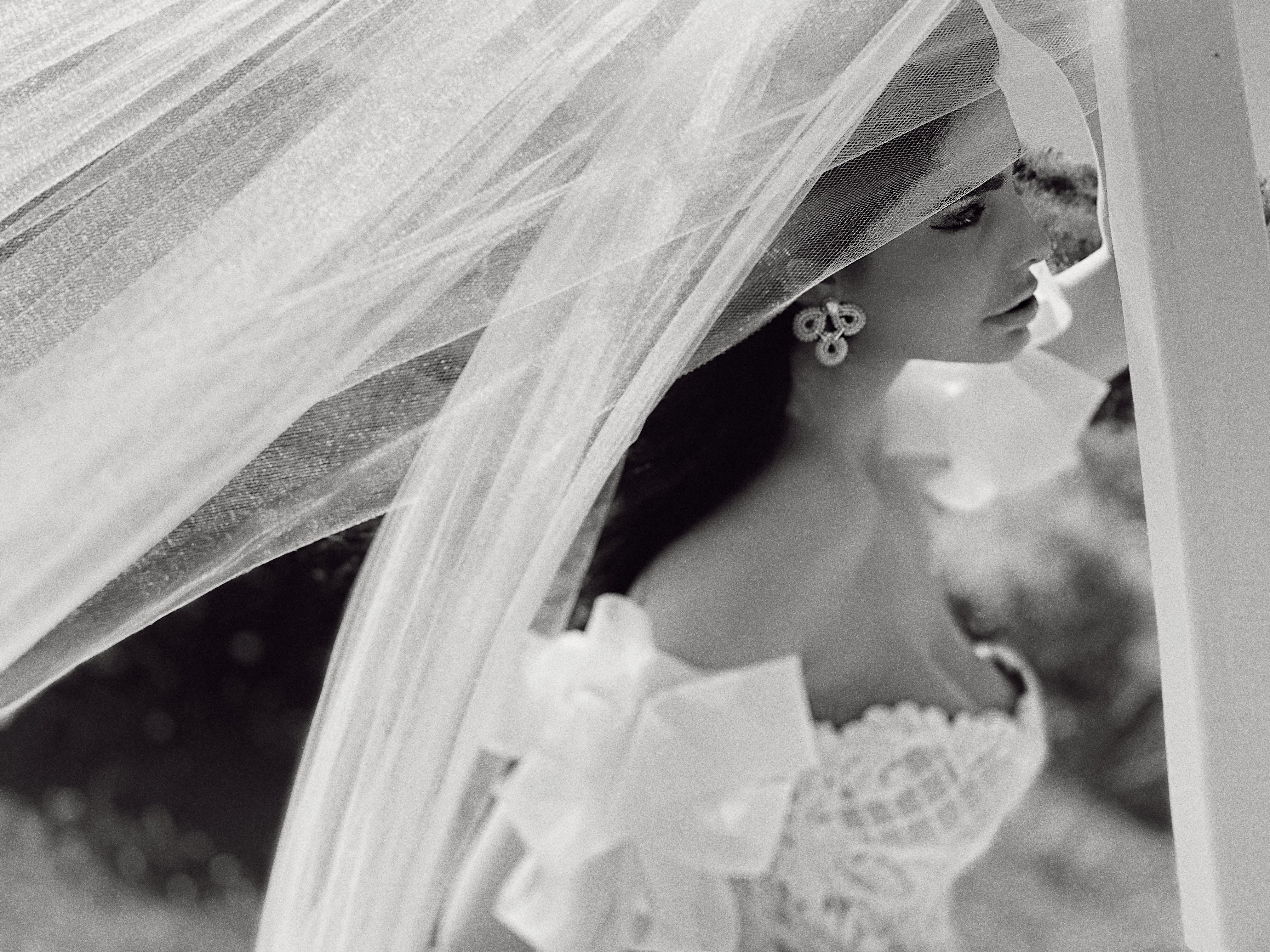 Closeup side view of corset sweetheart wedding dress with tulle veil