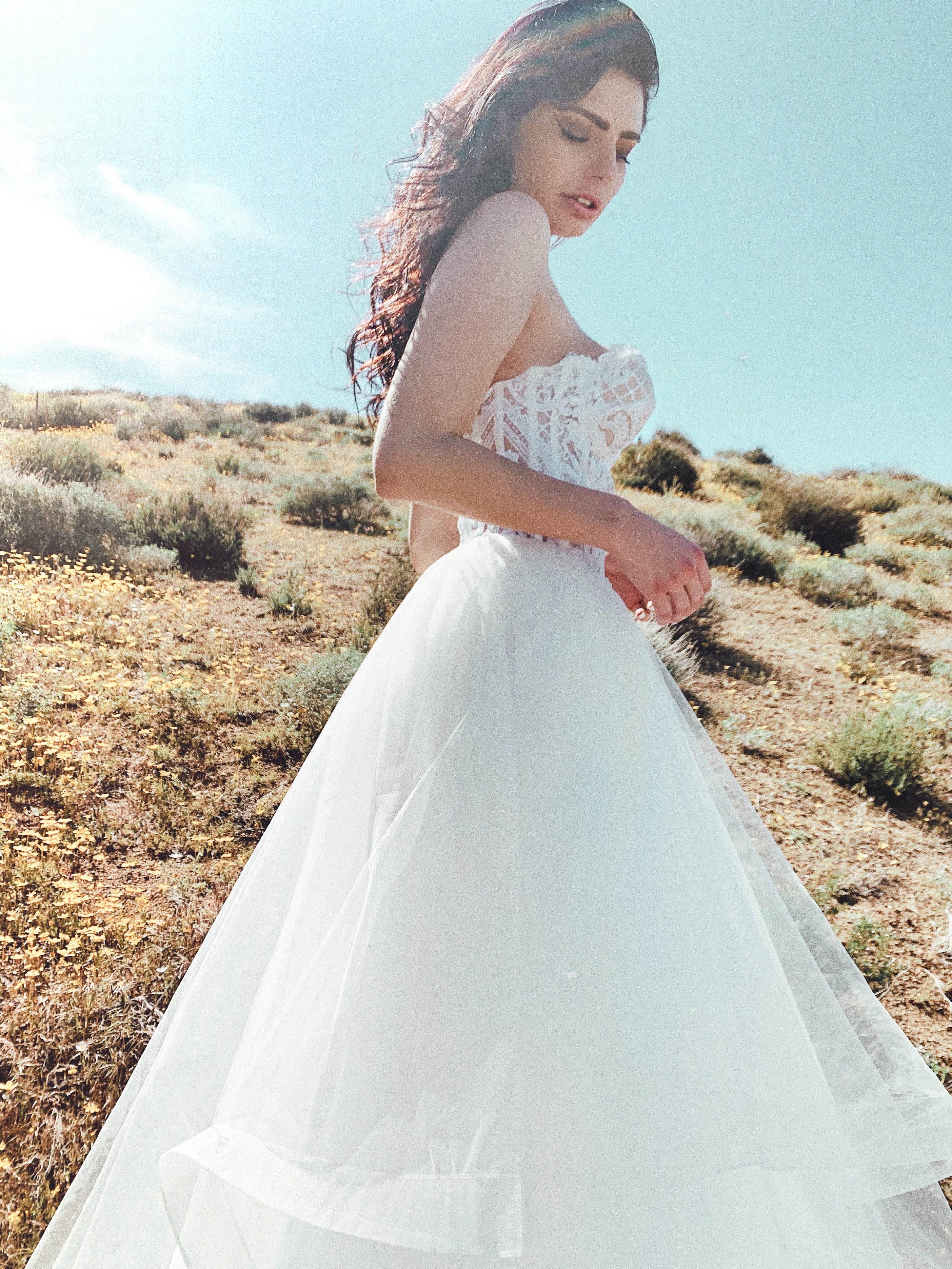 Closeup of sparkly sweetheart wedding dress with lens flare