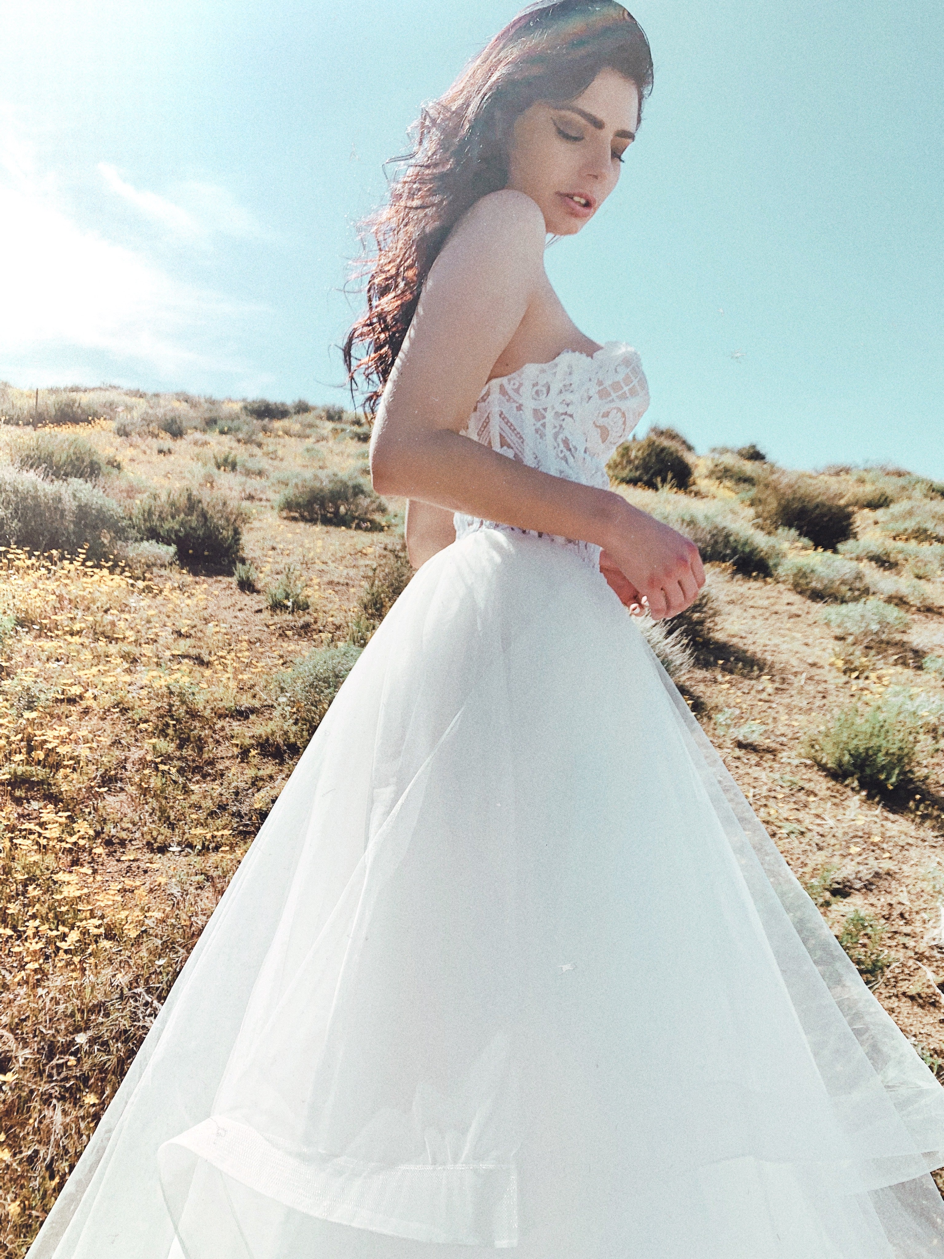 Closeup of sparkly sweetheart wedding dress with lens flare