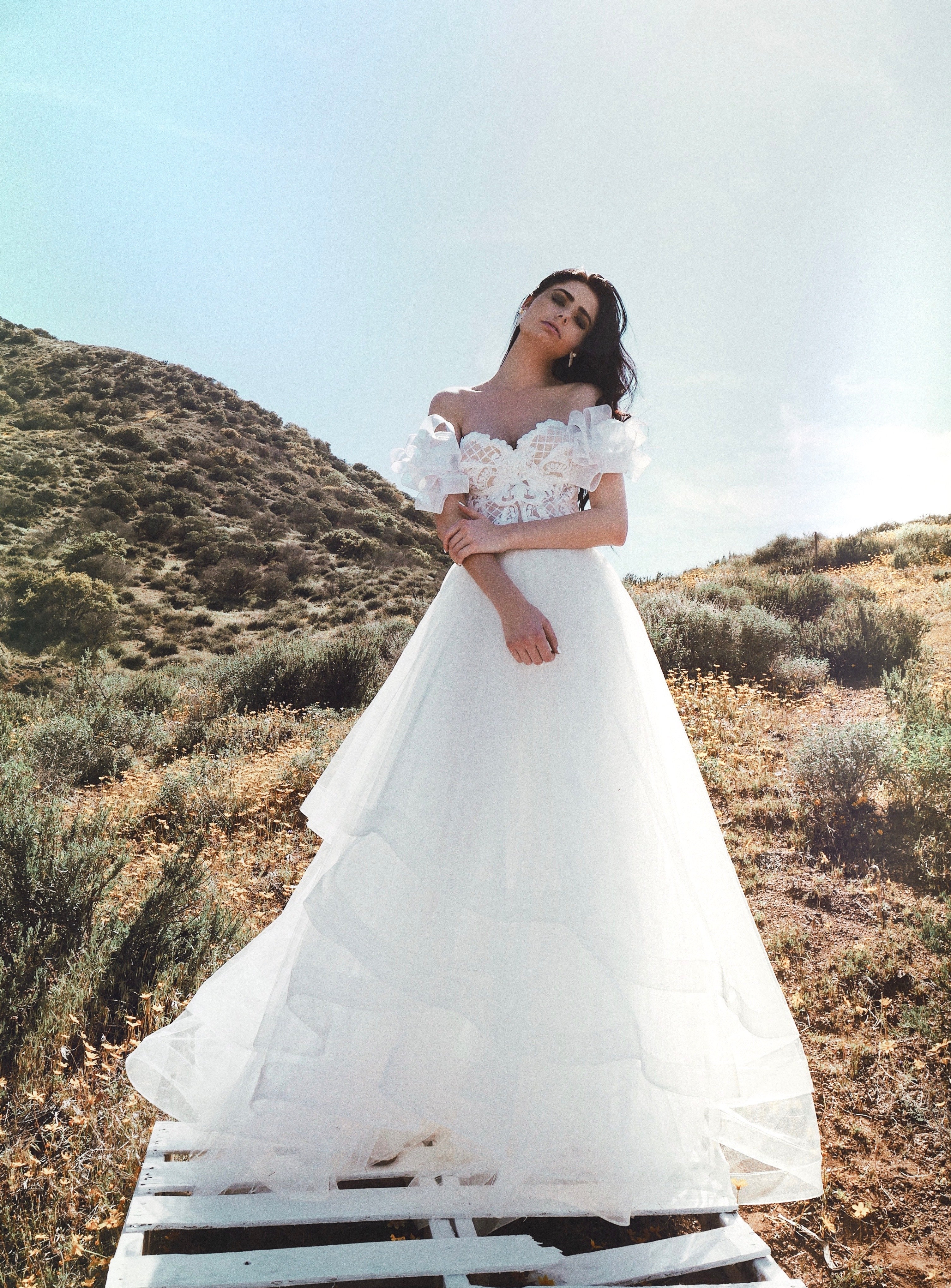 Tiered a line wedding dress with bow sleeves in field