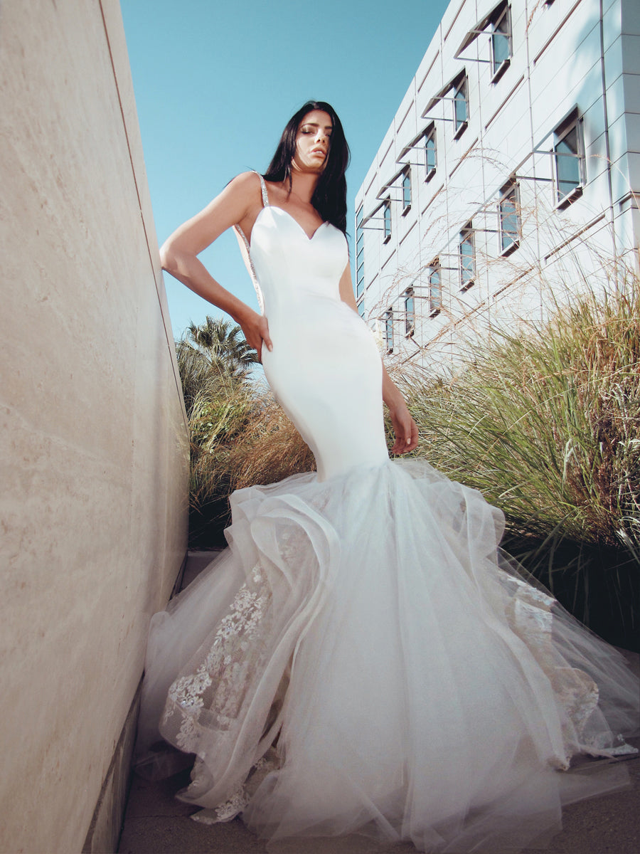 Front shot of satin wedding dress tulle in front of building