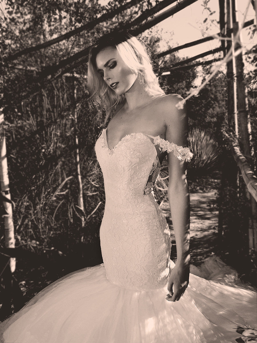 Off-the-shoulder sweetheart mermaid wedding gown with lace and tulle.