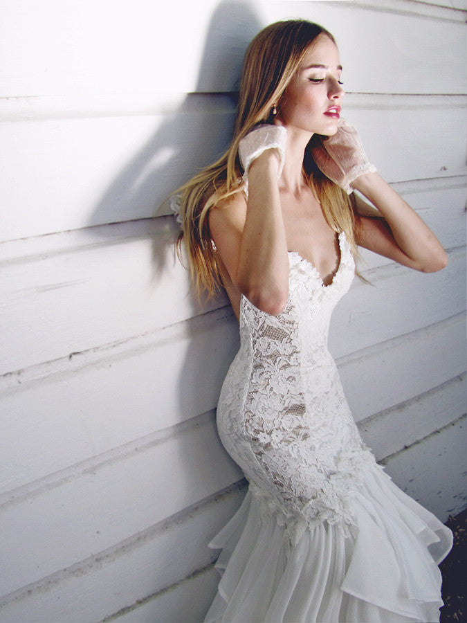 Sexy backless mermaid / trumpet wedding gown by Lauren Elaine. Plunging sweetheart bodice with floral lace detailing.