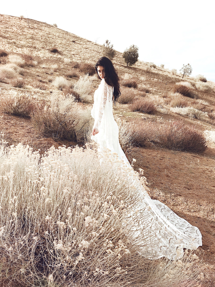 Romantic and bohemian a-line off-the-shoulder wedding dress with floral lace detailing from the affordable 'Pearl by Lauren Elaine' Bridal Collection