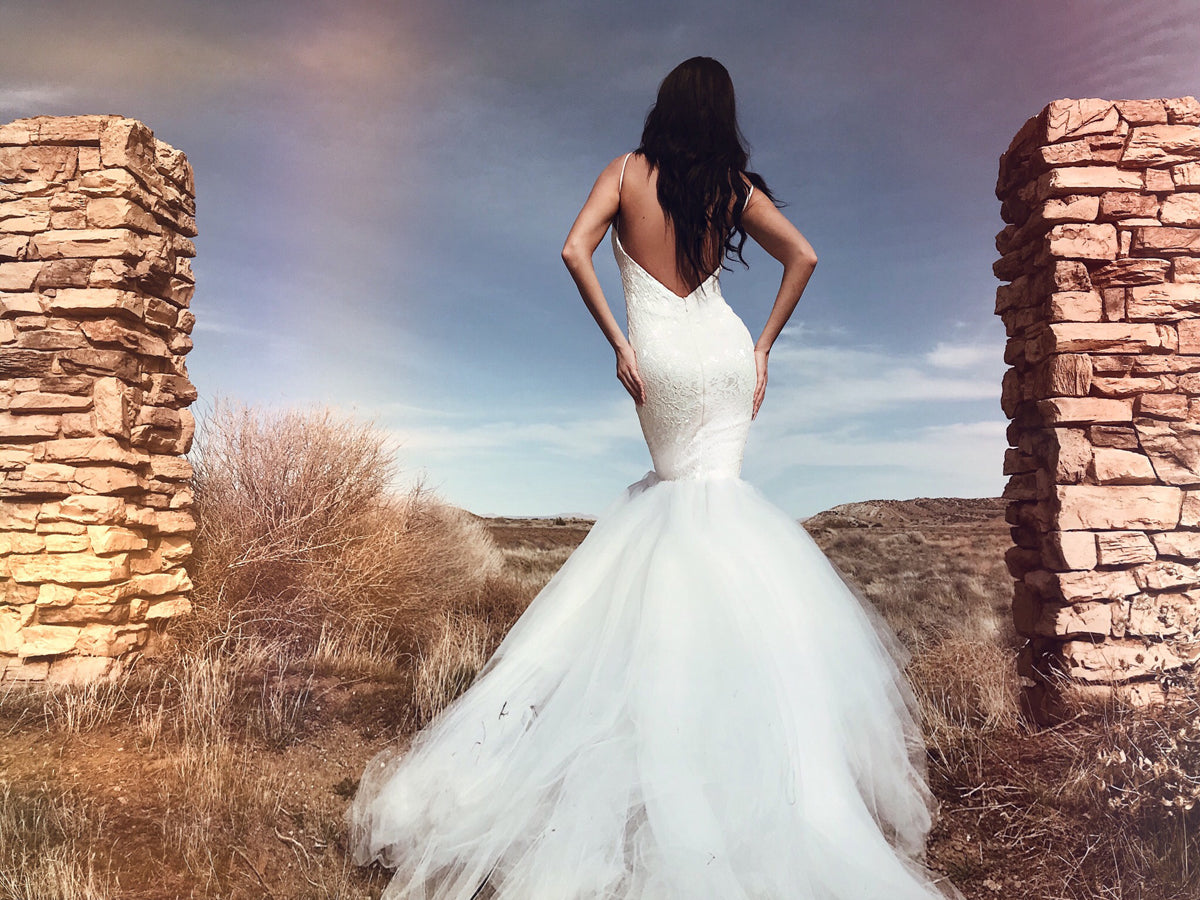 Sexy backless lace mermaid wedding dress with sequin crystal sparkle and cathedral train and spaghetti straps.