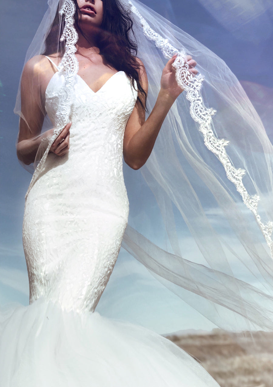 Flattering mermaid wedding dress with sparkling lace and form-fit silhouette. Lola from the Pearl by Lauren Elaine Bridal Collection.