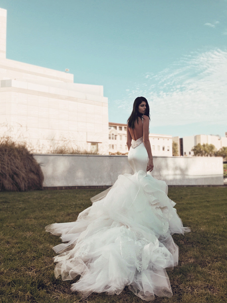 Satin mermaid wedding dress with detachable train on grass