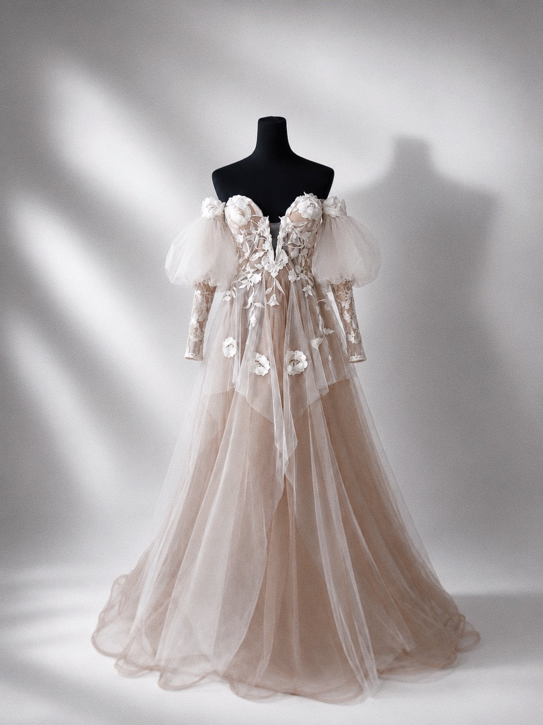Arrowyn ethereal wedding dress displayed on mannequin with illusion corset and detachable sleeves.