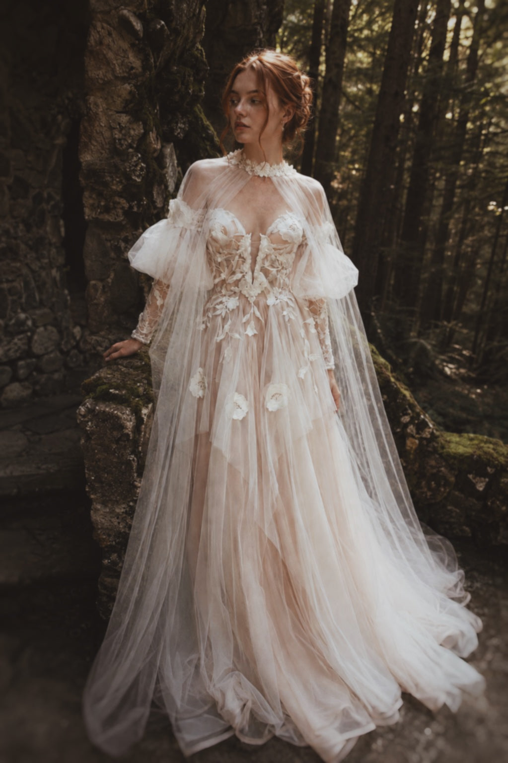 Arrowyn ethereal bridal gown with sheer floral cape and layered tulle skirt.
