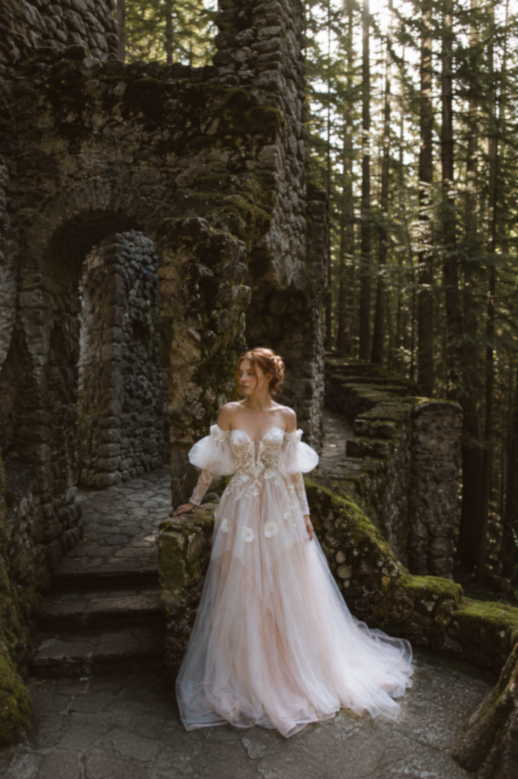 Arrowyn woodland-inspired wedding dress photographed among historic stone ruins.