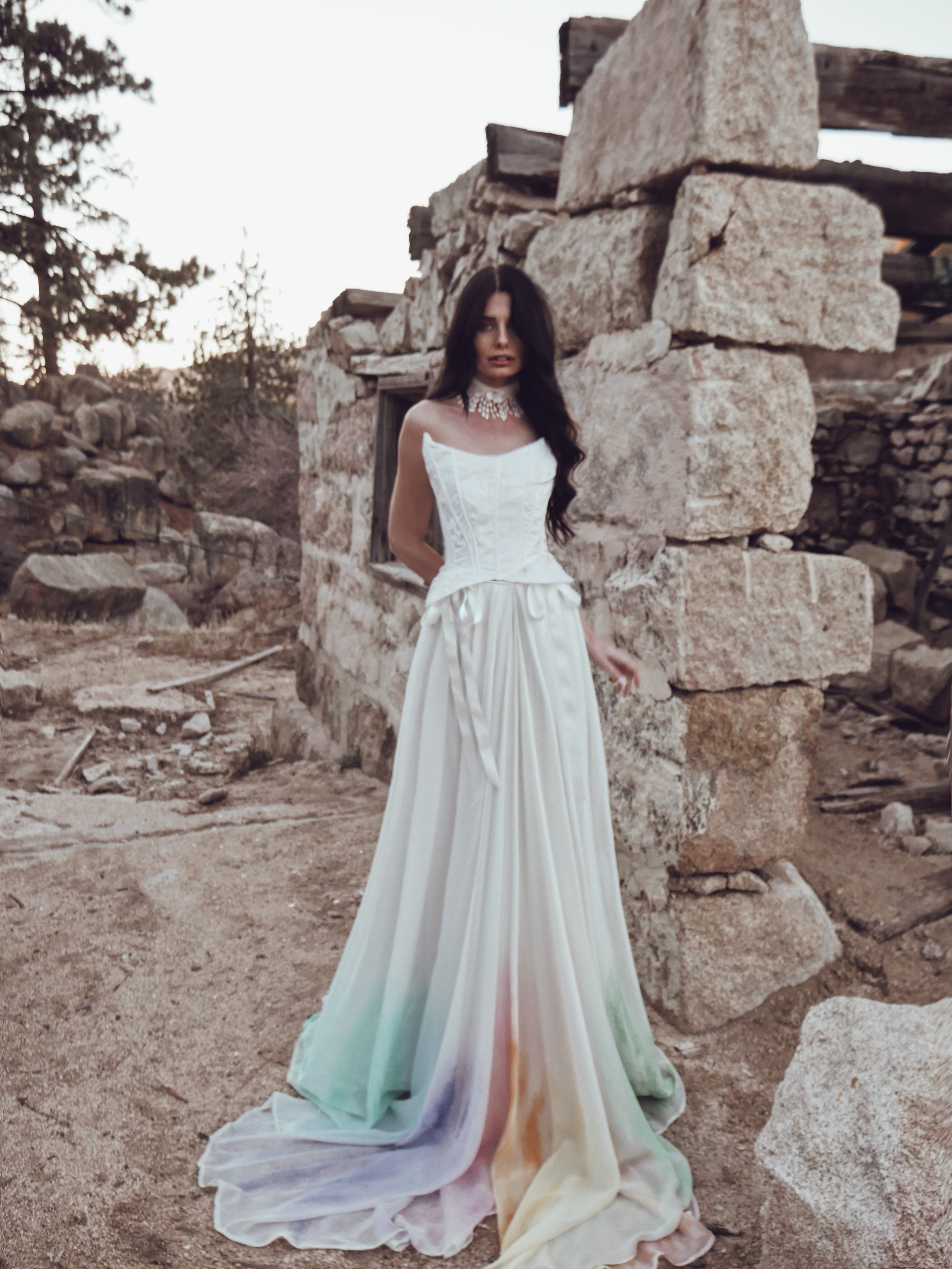 Bridal corset bodice with basque waist and peplum paired with a flowing skirt.