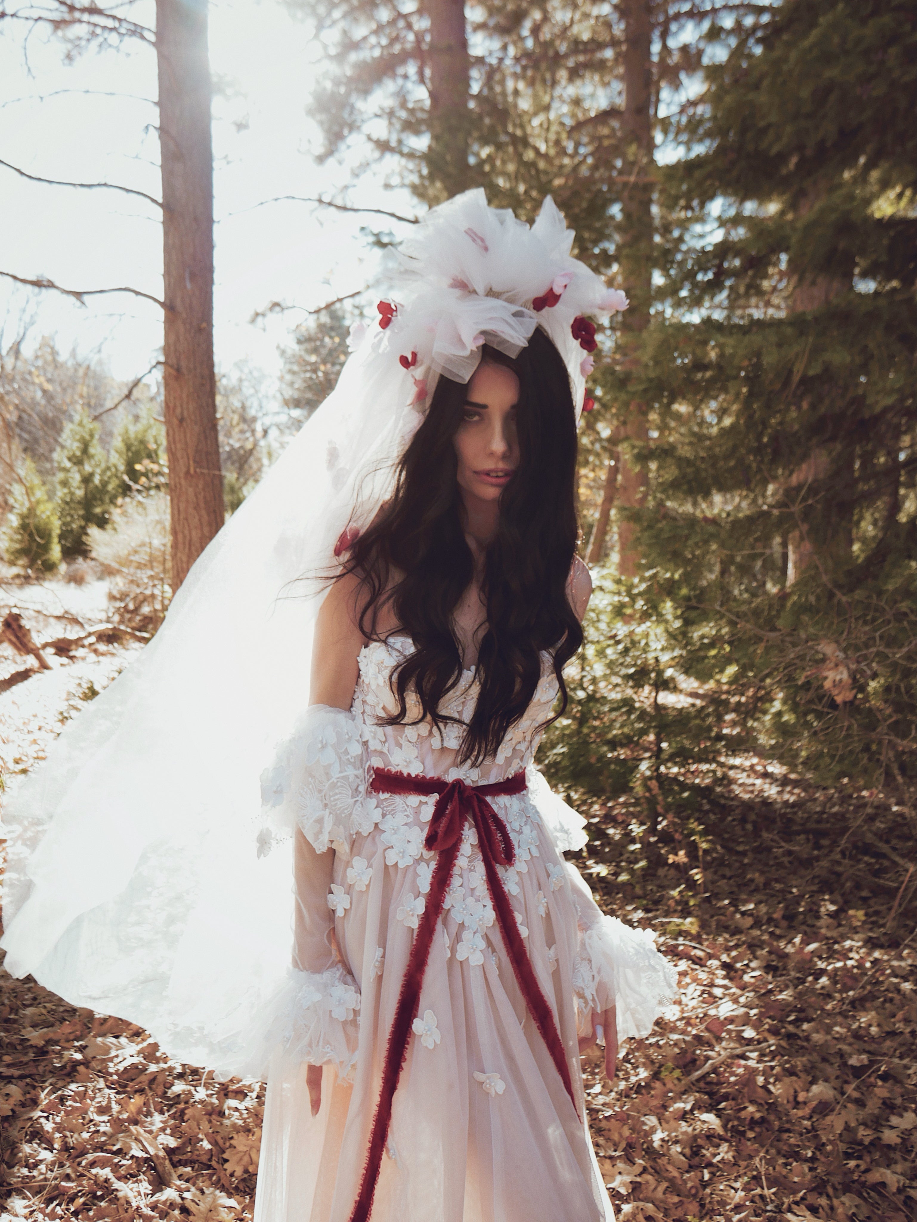Bride wearing the CHÉRIE vintage-inspired tulle veil with oversized 80s pouf and red floral appliqués by Lauren Elaine