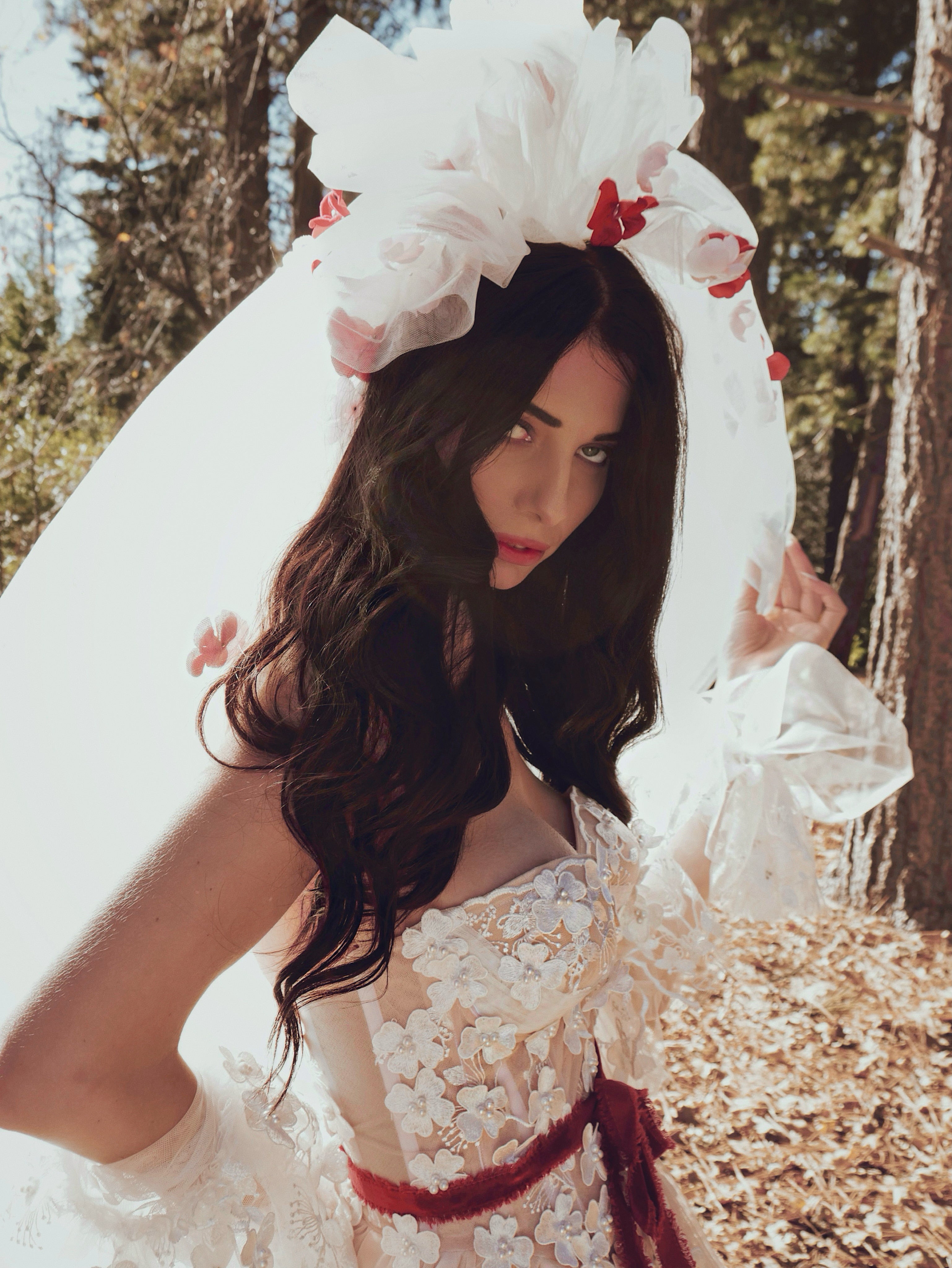 Romantic couture bridal close-up featuring the CHÉRIE tulle veil with dramatic 1980s-inspired volume and floral appliqués by Lauren Elaine.
