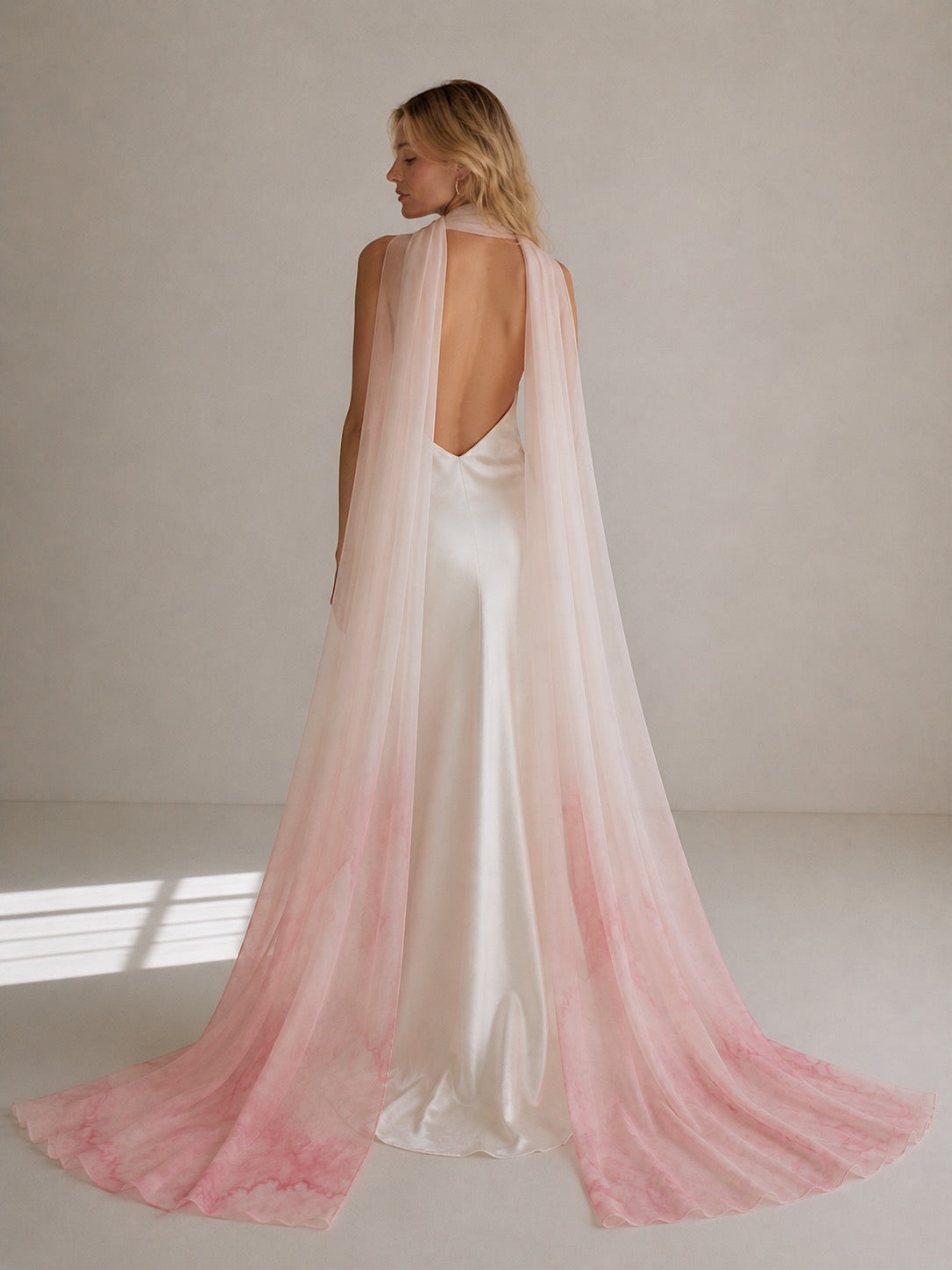 Back view of blush pink watercolor bridal neck scarf styled with open-back satin bridal gown