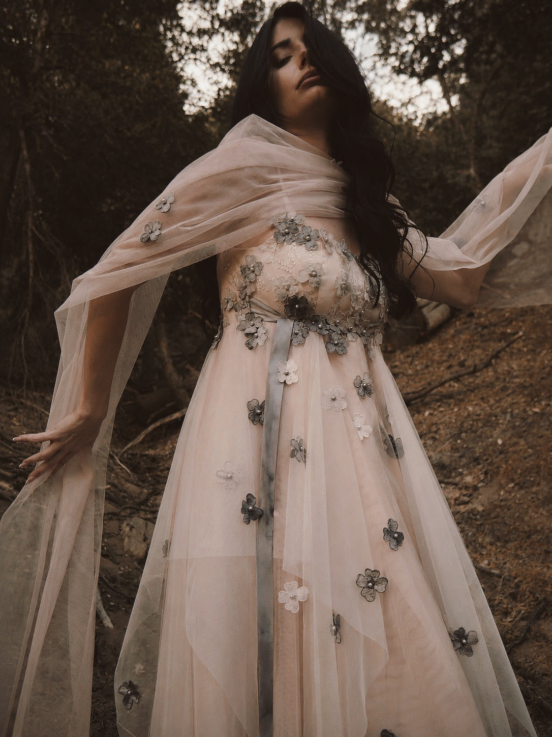 Close-up of Florêve Midnight floral appliqué wedding dress with gray 3D wildflowers and blush illusion tulle