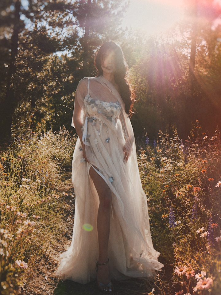 Florêve colorful floral wedding gown with blue wildflower appliqués photographed in a woodland wildflower setting