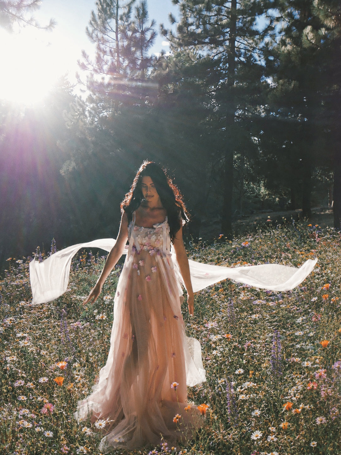 Florêve colorful floral wedding dress surrounded by woodland wildflowers with flowing sheer tulle
