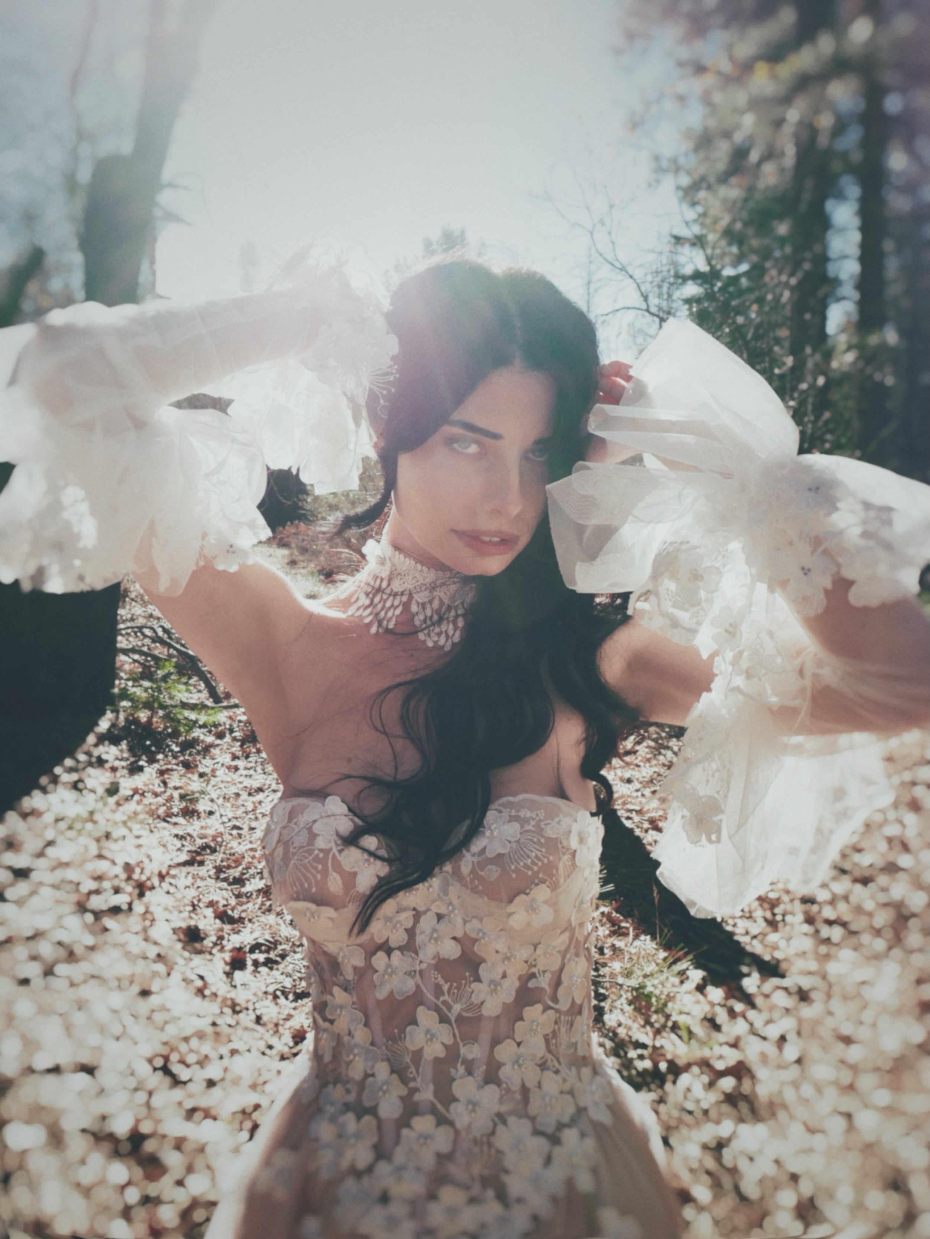 Boho bridal choker with crochet lace fringe, styled with an ethereal floral wedding dress in a natural outdoor setting