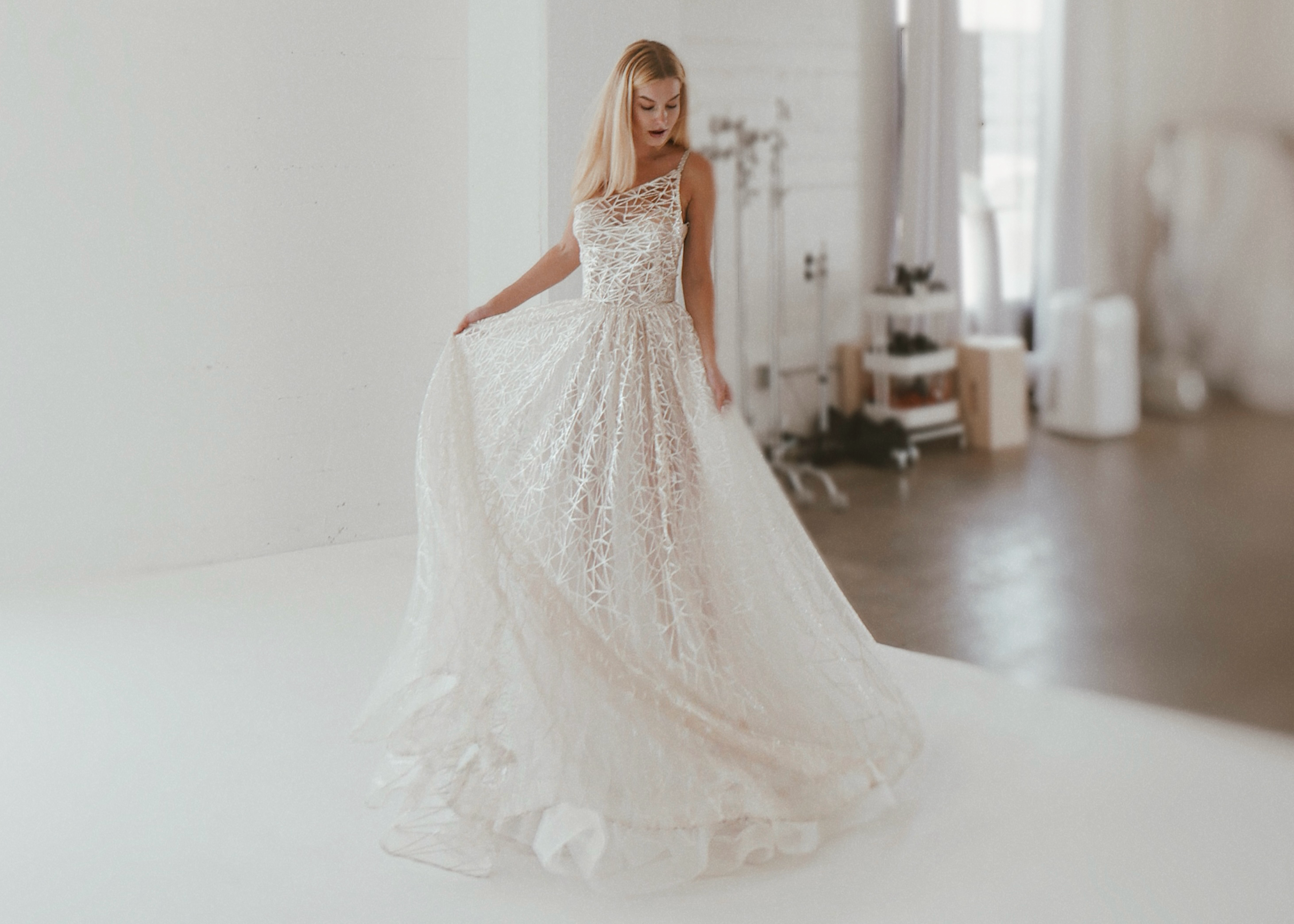 Couture geometric lace ball gown in a Los Angeles bridal studio for Luxe wedding dress appointments.