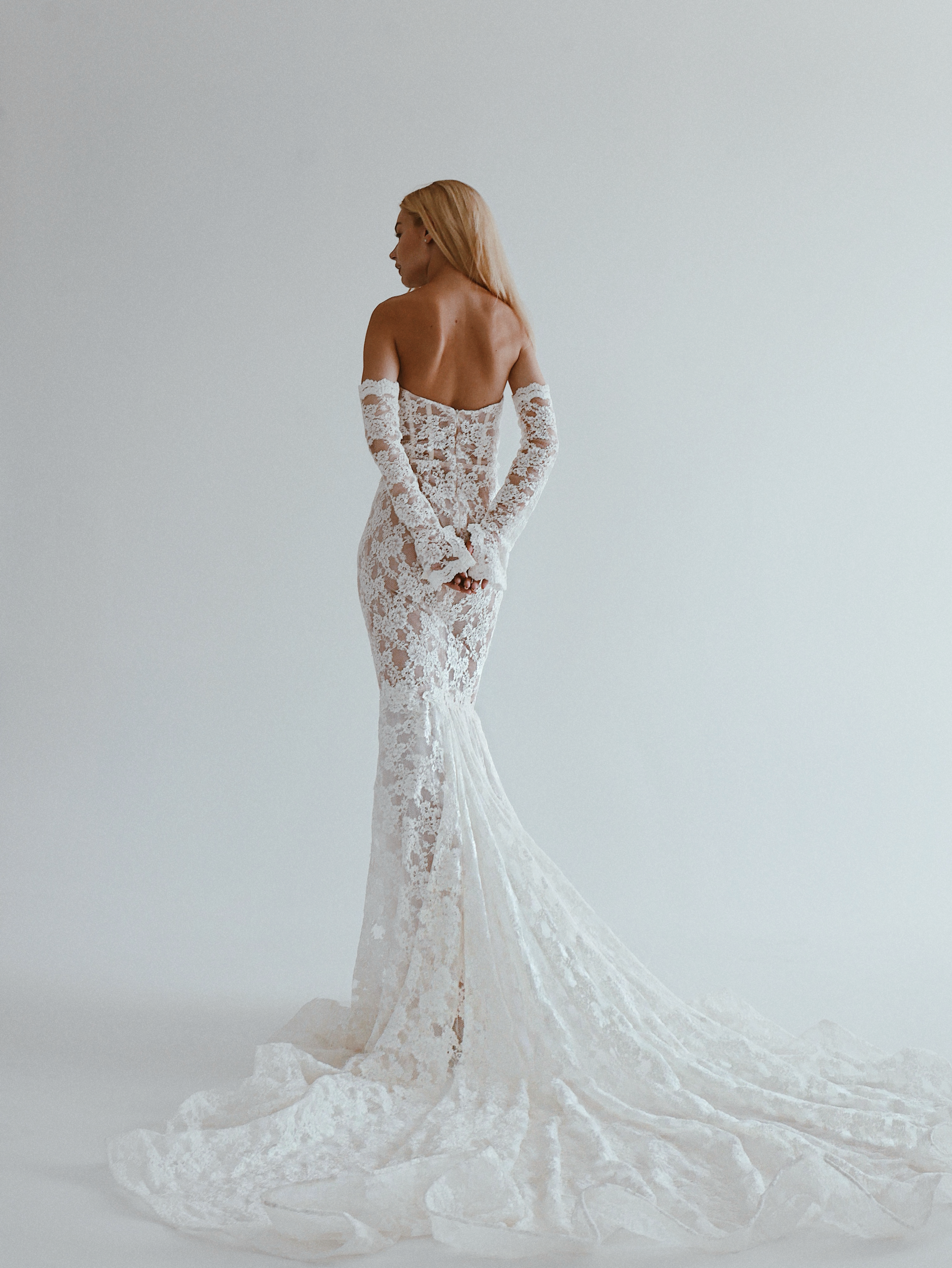 Back view of a lace wedding gown with matching sleeves at a Luxe private bridal appointment in Los Angeles.
