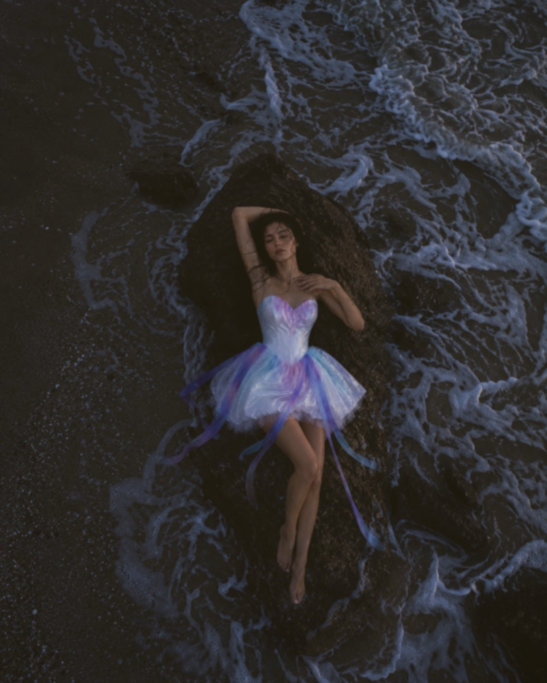 Overhead editorial of Moondreamer Mini colorful bridal dress with pastel watercolor satin and flowing ribbon details
