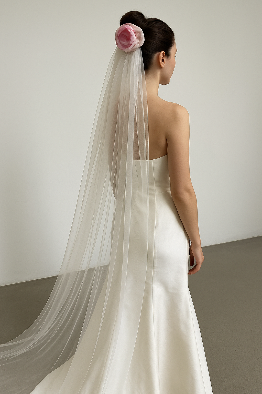 Bride wearing blush silk taffeta rose bridal veil with long cascading tulle