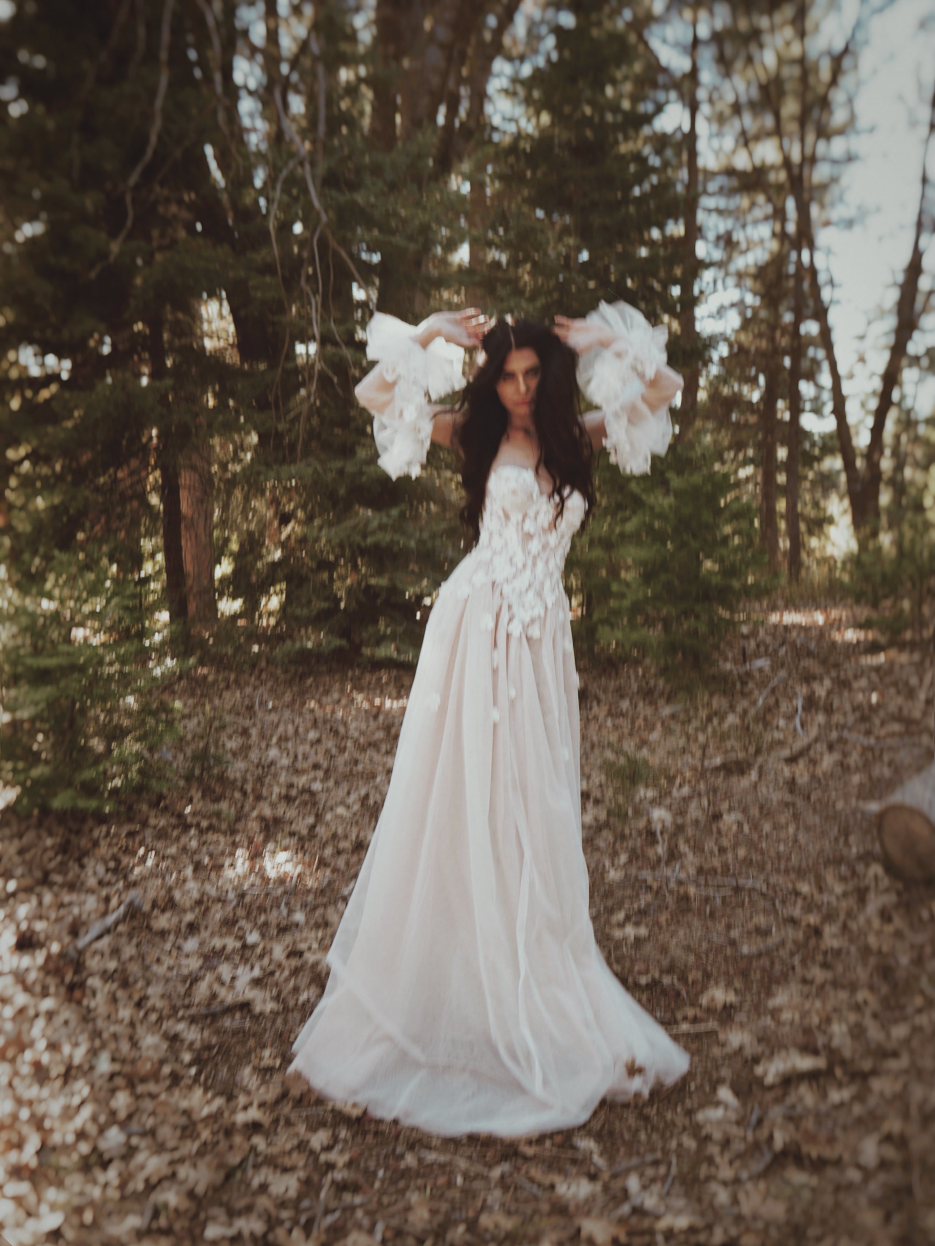 Valen ethereal floral wedding dress by Lauren Elaine featuring a sheer corset bodice, 3D floral lace appliqués, and detachable floral tulle sleeves