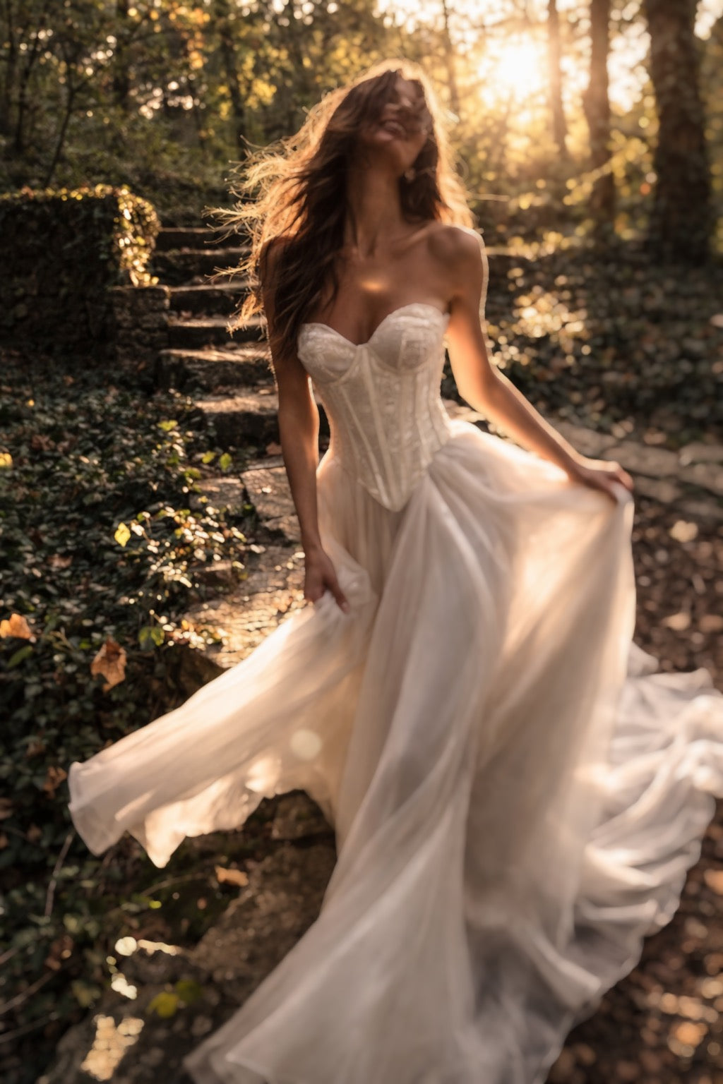 Cadence basque waist corset wedding dress in floral jacquard with flowing chiffon skirt in romantic forest setting by Lauren Elaine Bridal