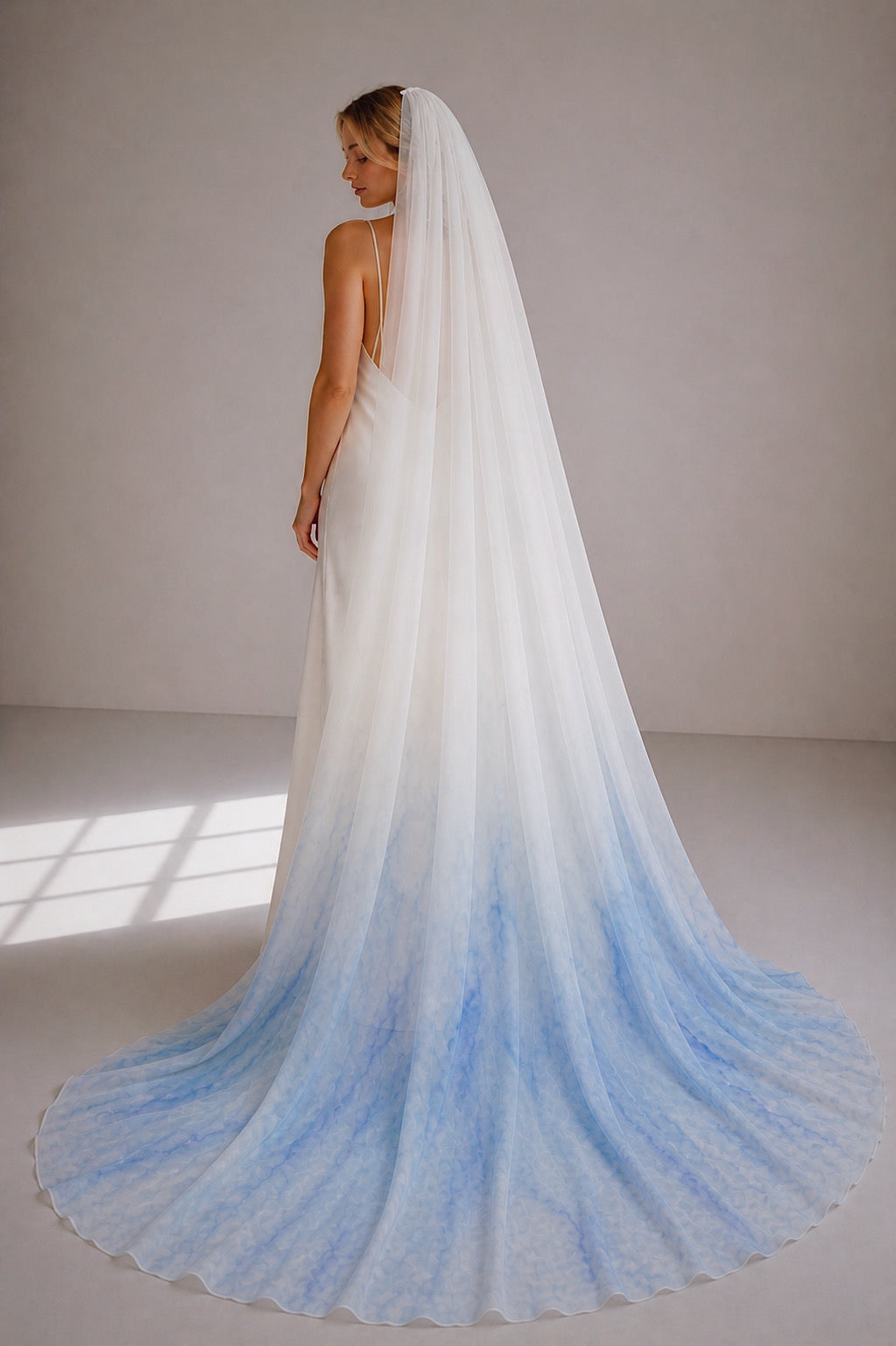 Chroma veil blue ombre wedding veil in sheer chiffon with soft watercolor gradient and cathedral length train