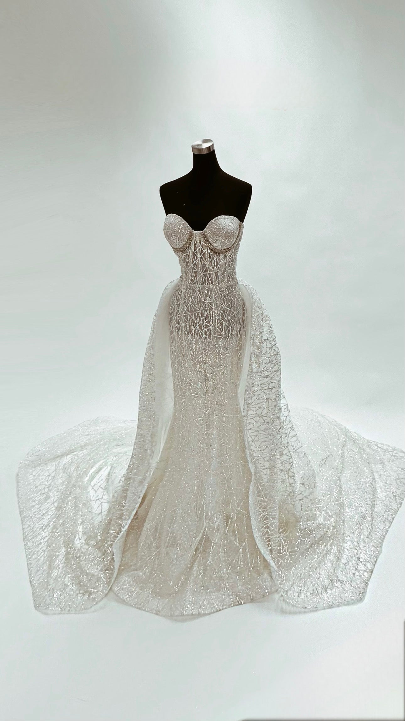 Luxury bridal gown on mannequin in white studio at Lauren Elaine Bridal Los Angeles