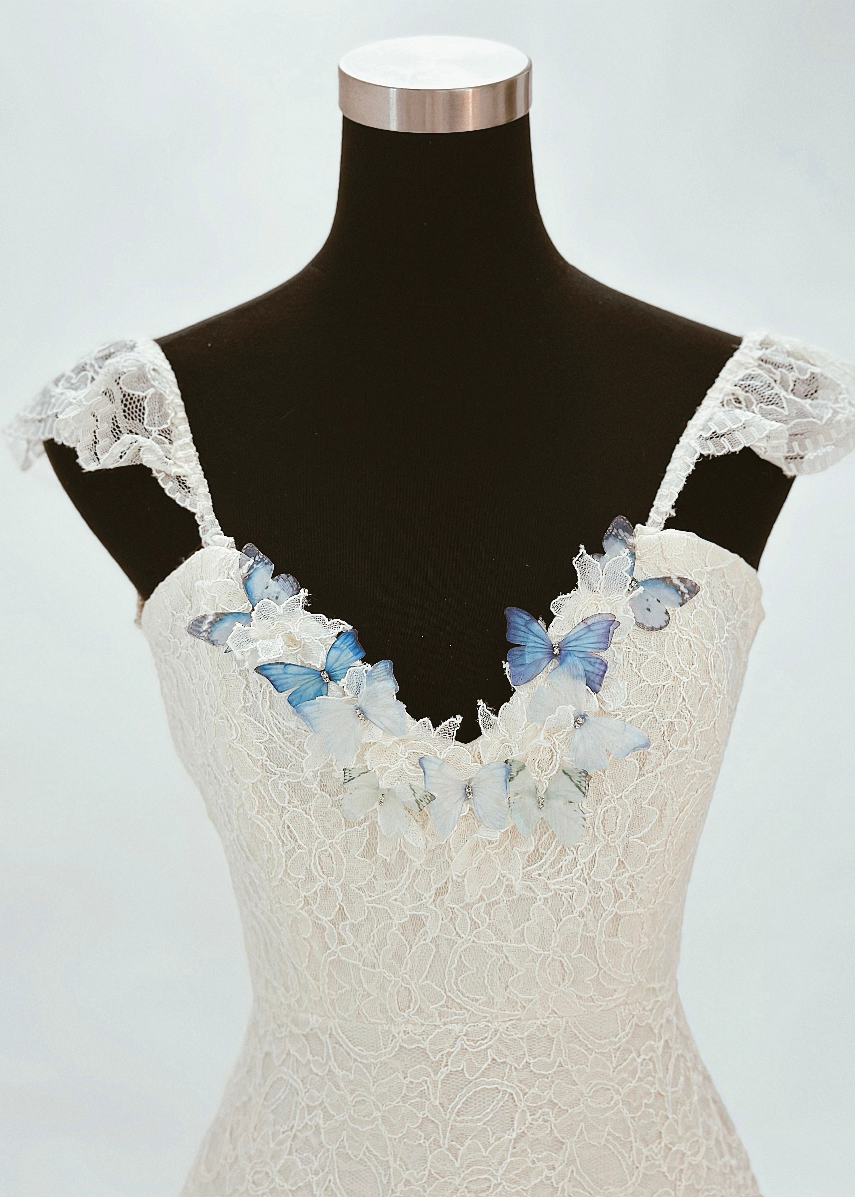 3D rainbow butterfly detailing on the neckline of a mermaid wedding dress
