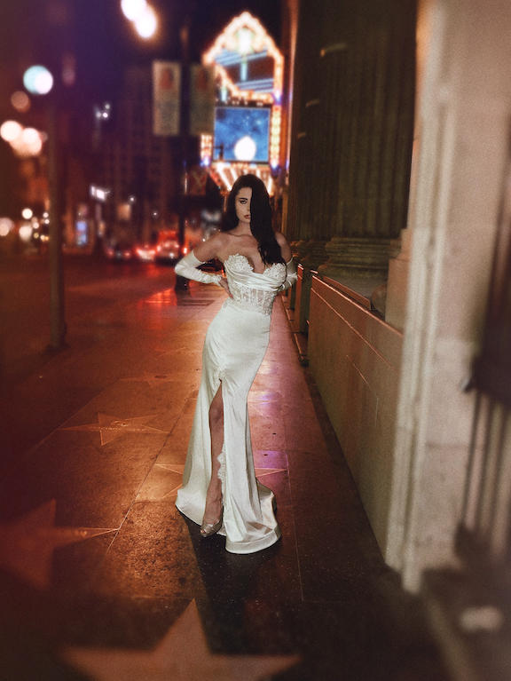 A model stops traffic on Hollywood Blvd in a Lauren Elaine Encore Corset Satin Trumpet Gown w/slit