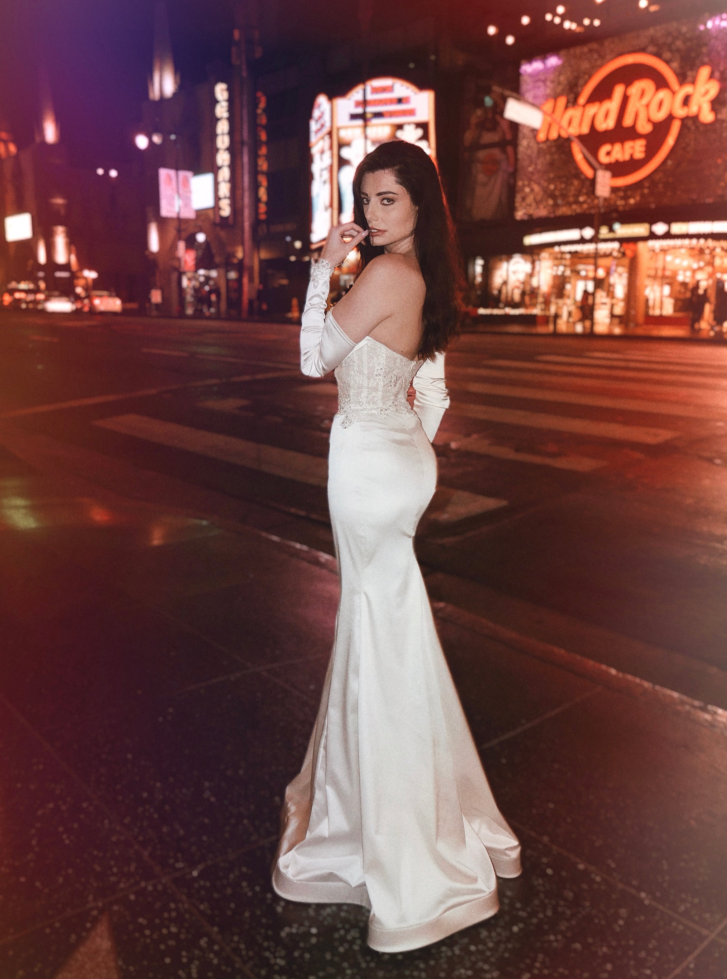 A model stops traffic on Hollywood Blvd in a Lauren Elaine Encore Corset Satin Trumpet Bridal Gown 