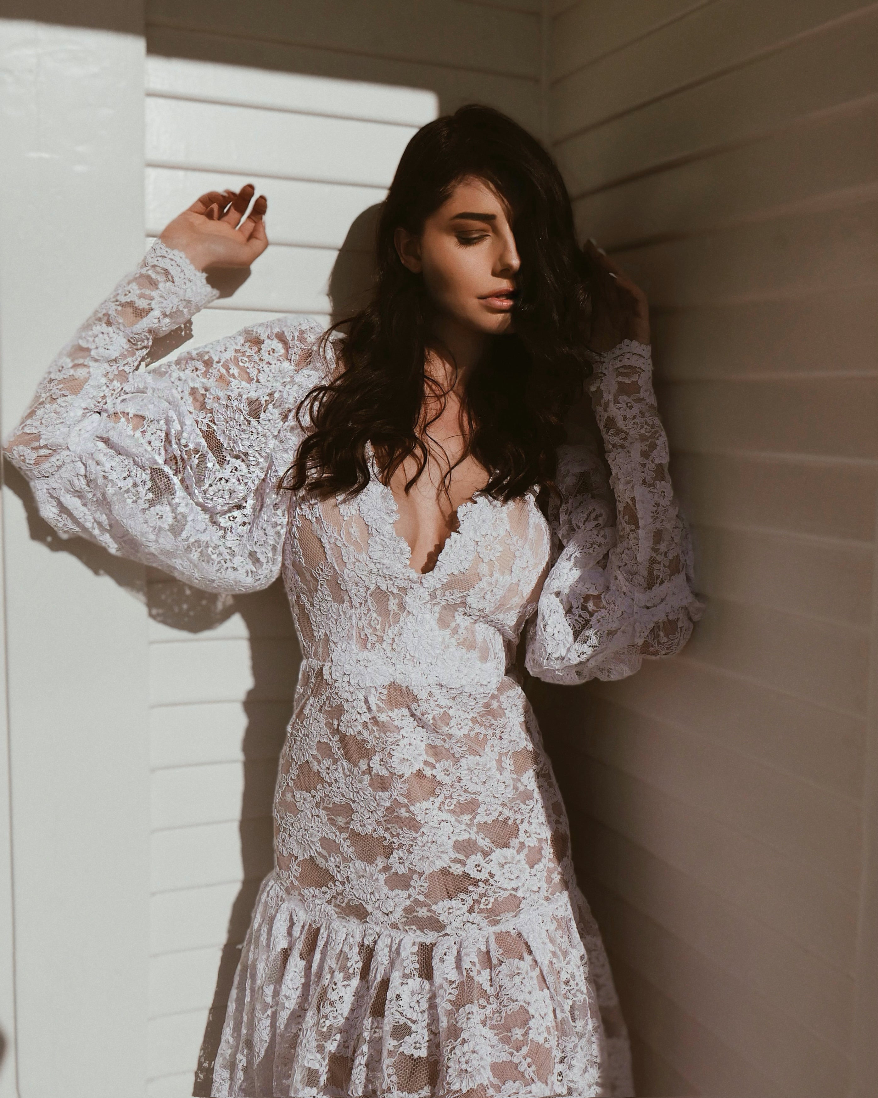 Front - A model poses in the Lauren Elaine "Meadow" gown with lace sleeves.