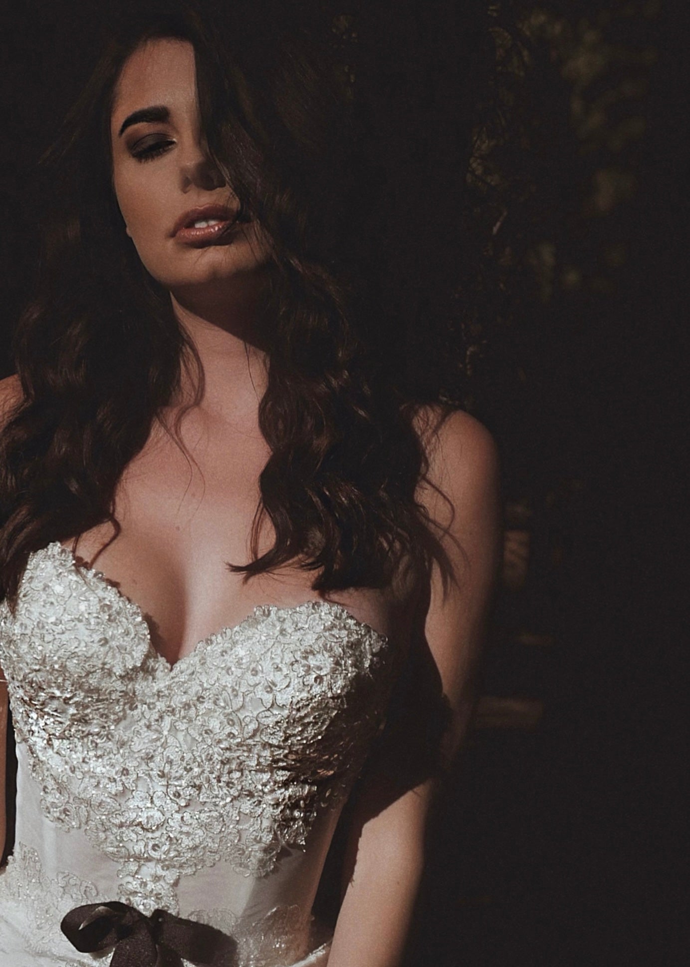 Details on a lace corset mini wedding dress with bow by Lauren Elaine Bridal
