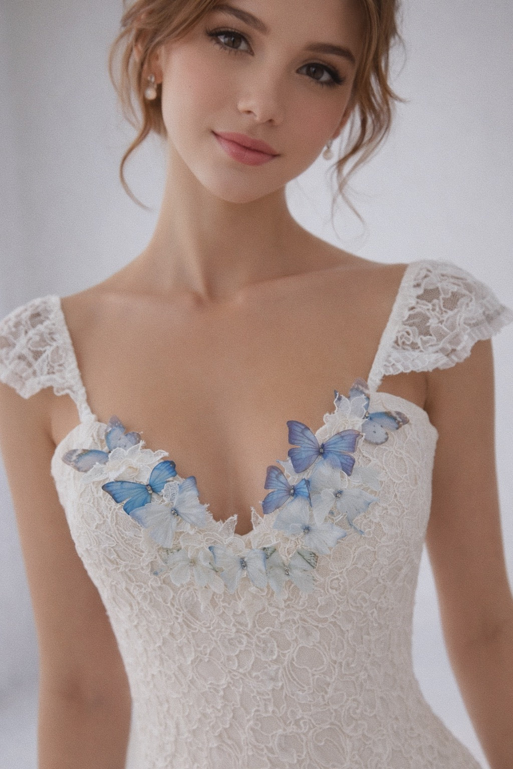 Close-up of rainbow butterfly appliqués on lace bodice of a couture rainbow wedding dress