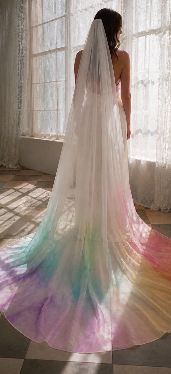 A bride wears a rainbow chiffon watercolor wedding veil by Lauren Elaine 