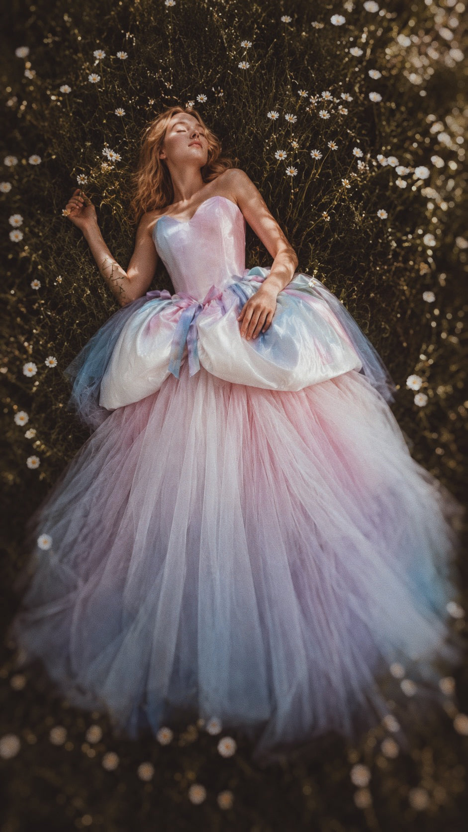 Pastel rainbow wedding gown with watercolor satin corset bodice and ombré tulle ball gown skirt photographed in a dreamy wildflower meadow as part of Lauren Elaine's Technicolor Fairytale Collection.
